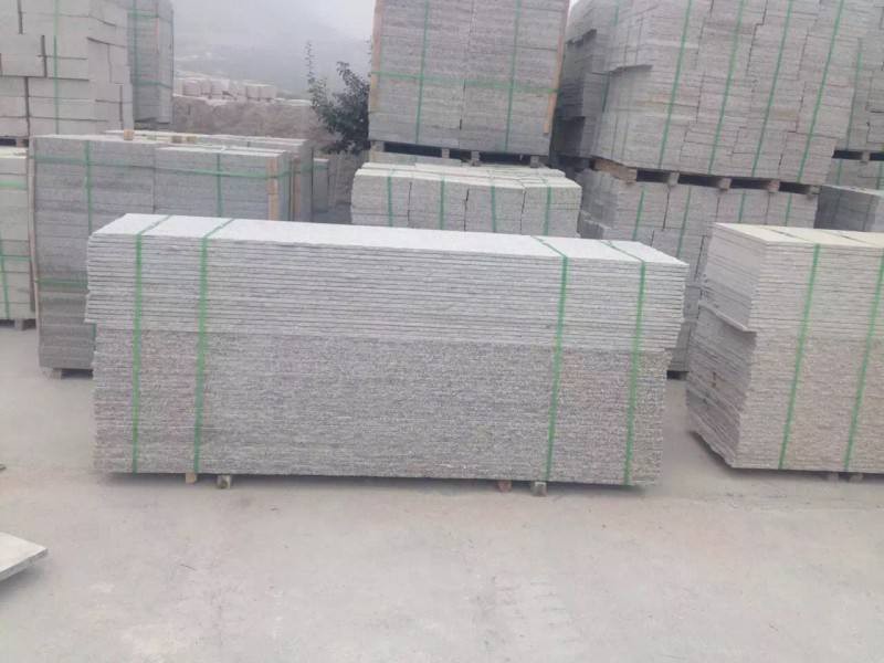 Stacks of neatly cut stone slabs prepared for further processing, demonstrating the precise cutting ability of the wire saw machine.