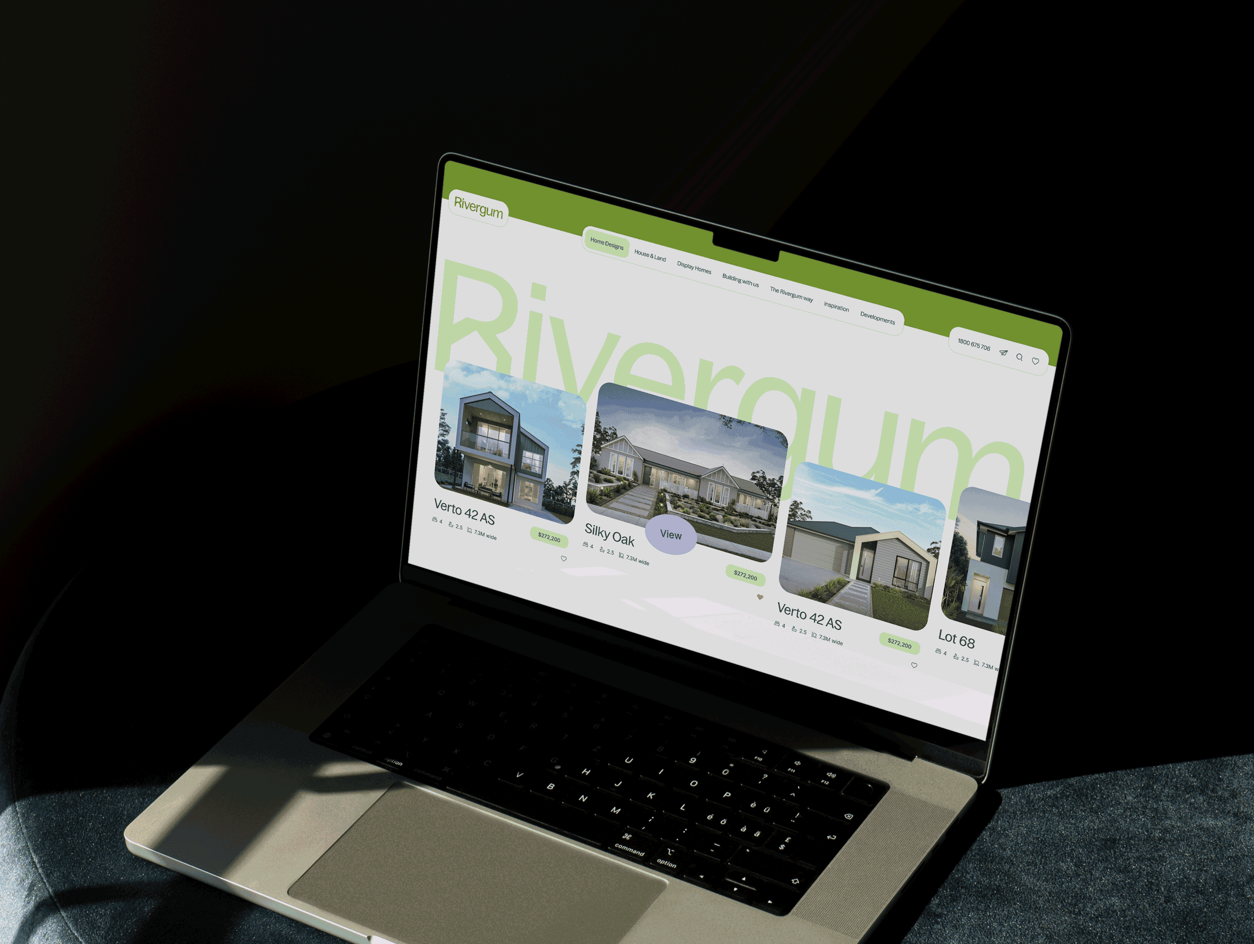 Rivergum Homes homepage, shown on a laptop on a cushion.