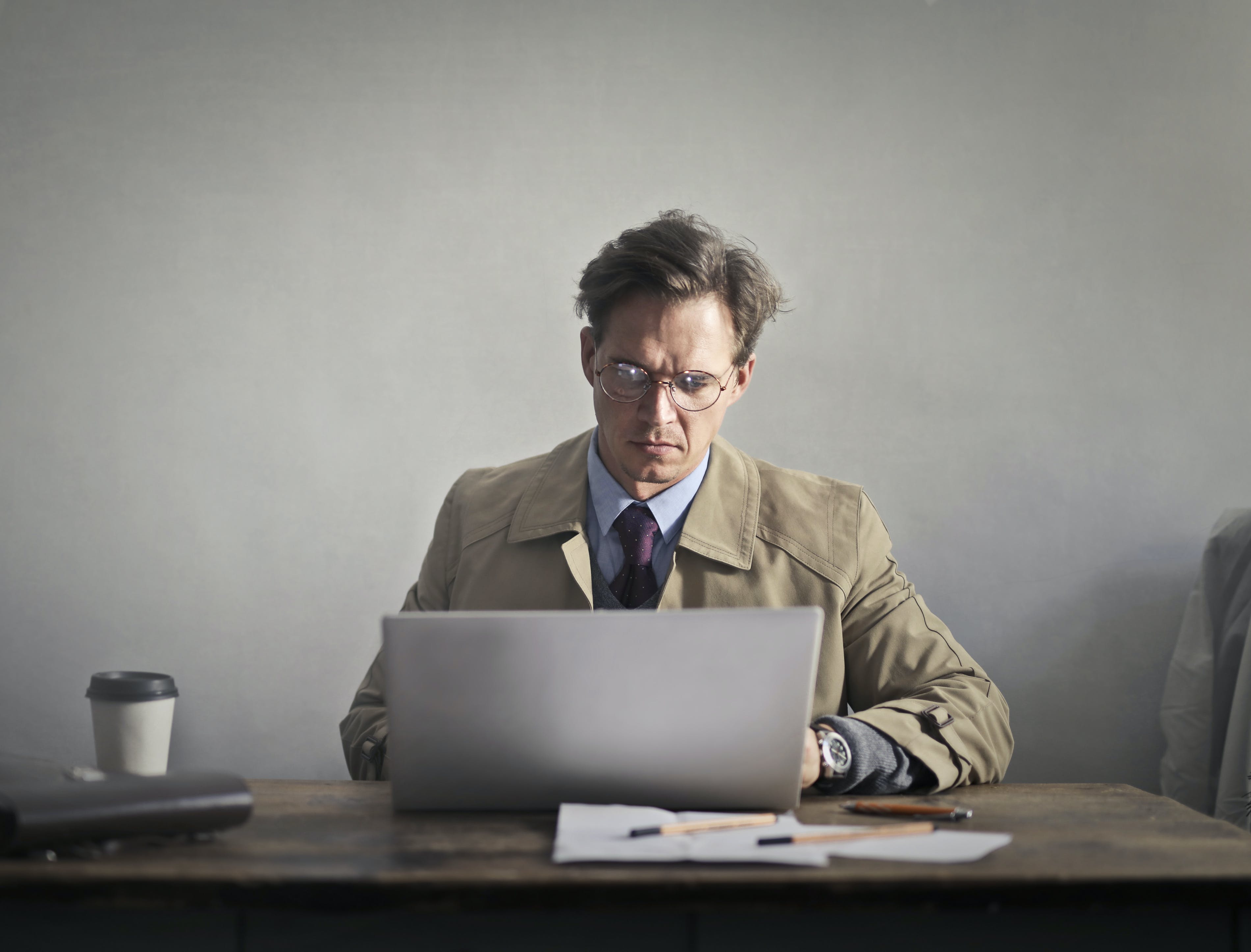 Man in brown suit studying the types of cold outreach email