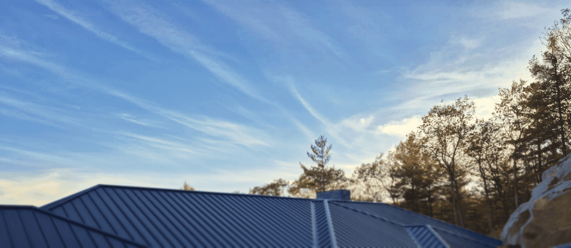 a close up of a roof with a blue sky in the background