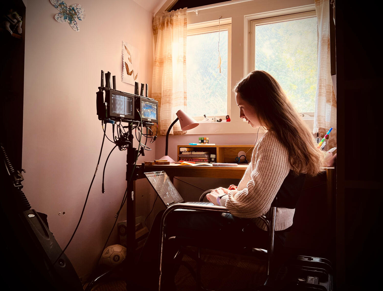 Erin Middleton working on a computer on a film set in a production role prior to book editing career.