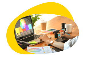 Graphic designer creating visual designs on a laptop