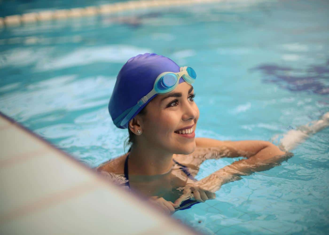 Woman swimming in an indoor pool to burn calories