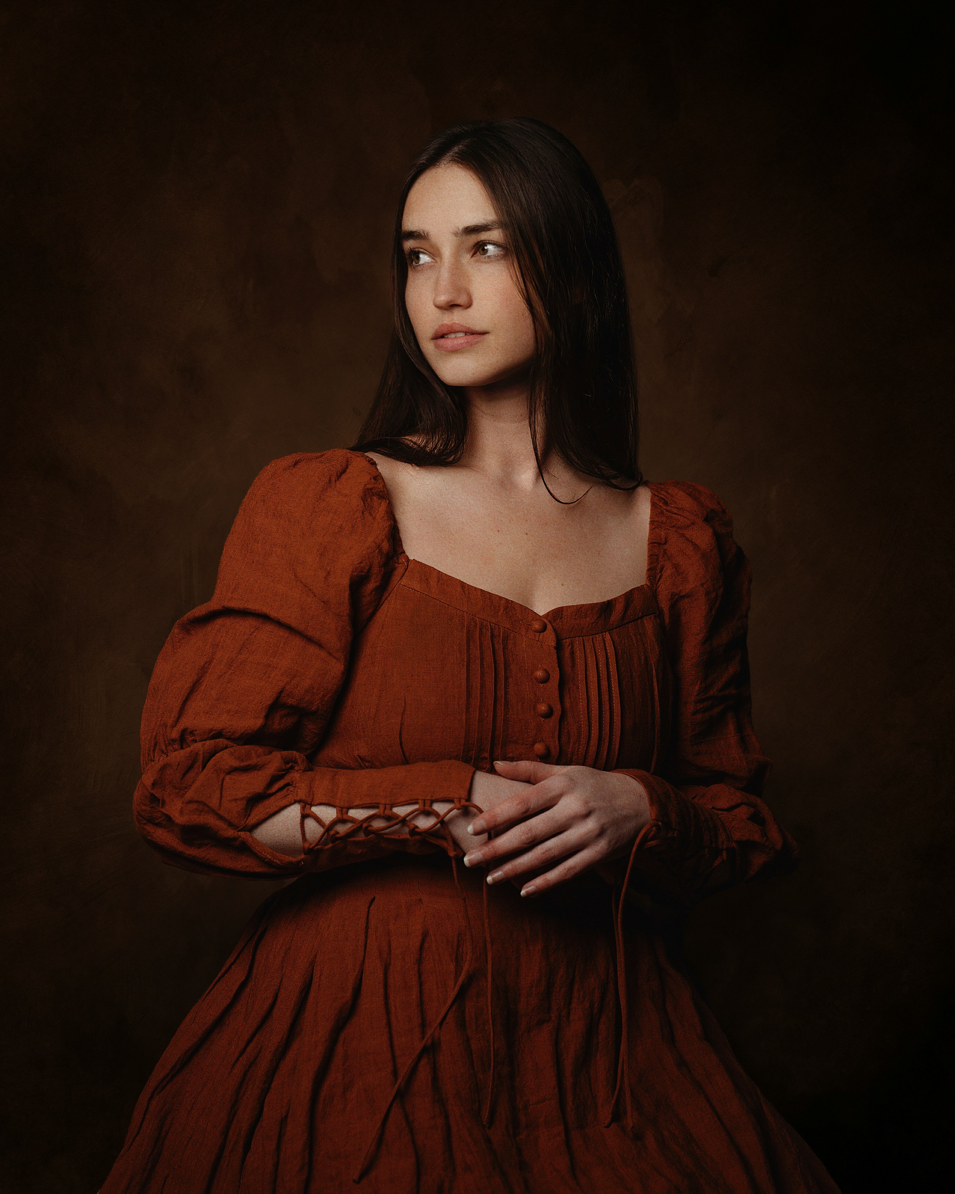 A woman in a striking red dress poses for a picture, showcasing her style and confidence.