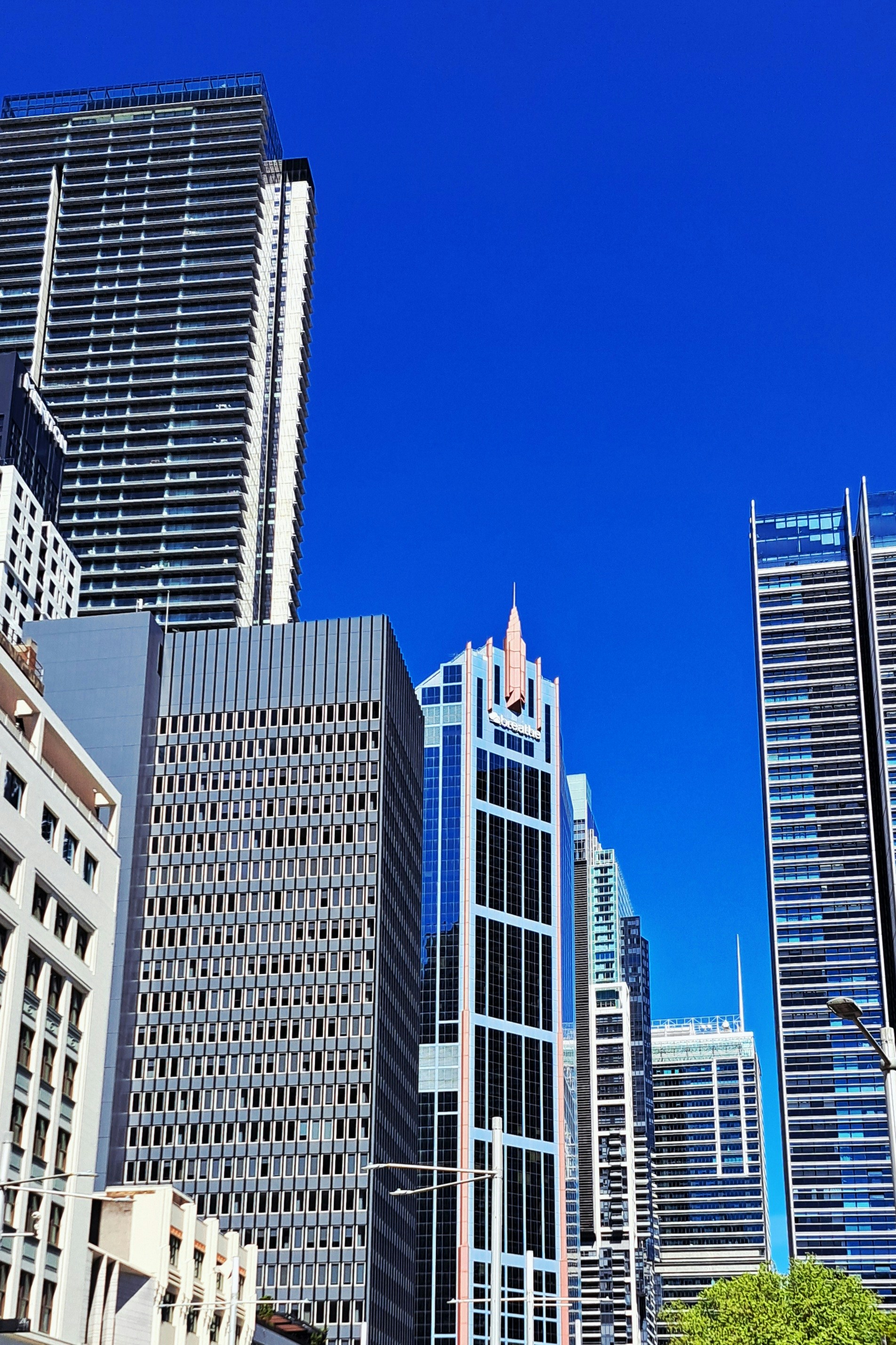 Modern skyscrapers against a clear blue sky.