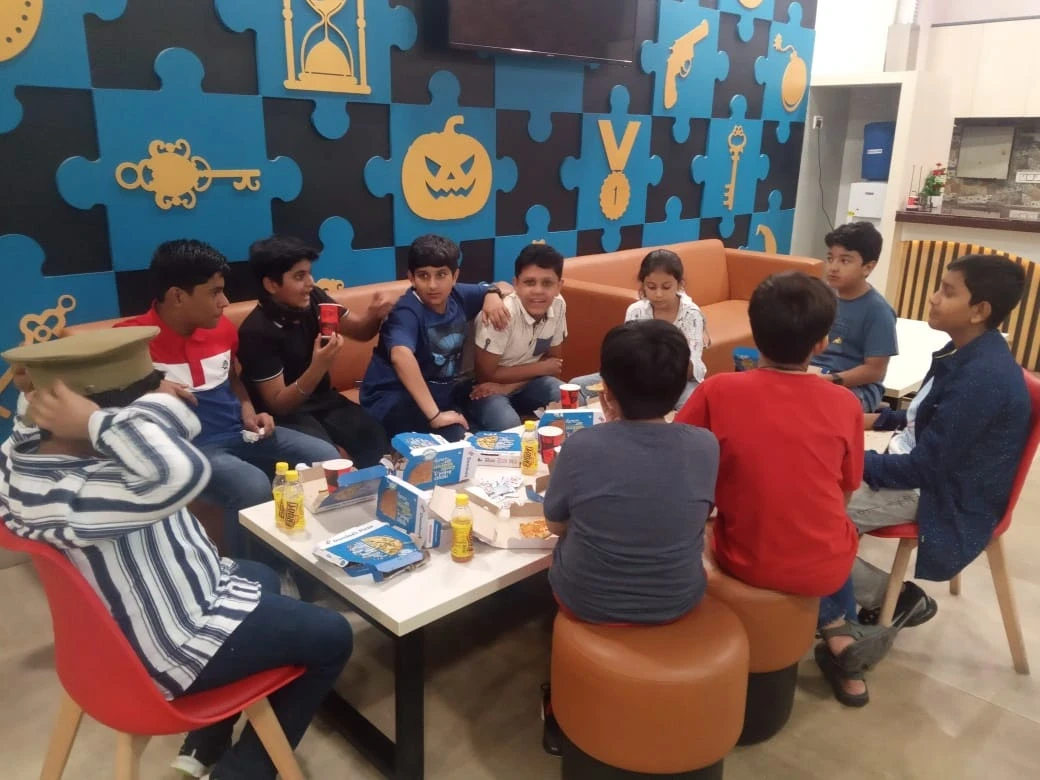 5 Teens posing with props after a birthday escape game at MGF Metropolis Mall Gurugram