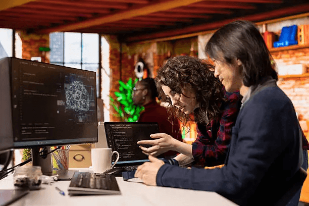Layered blue mountains fade into a soft pink sky.