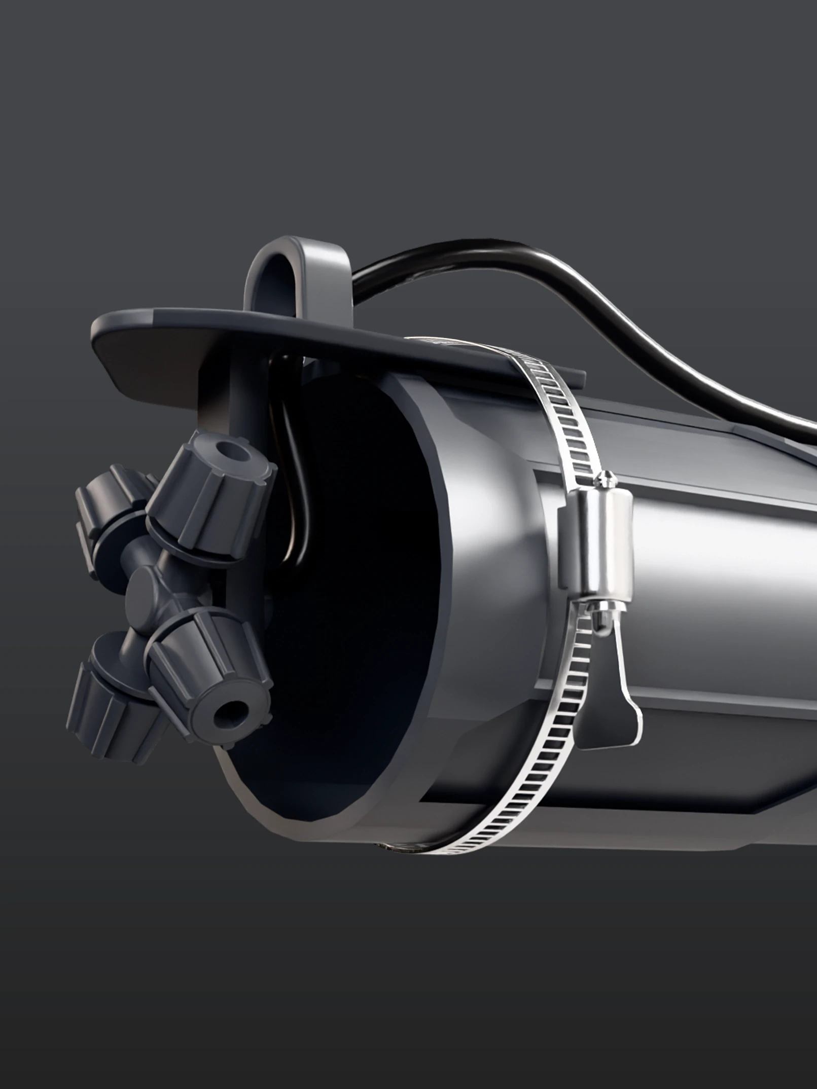 Close-up of a metallic mechanical component with multiple nozzles and a clamp against a dark gray background, conveying a sleek, industrial feel.