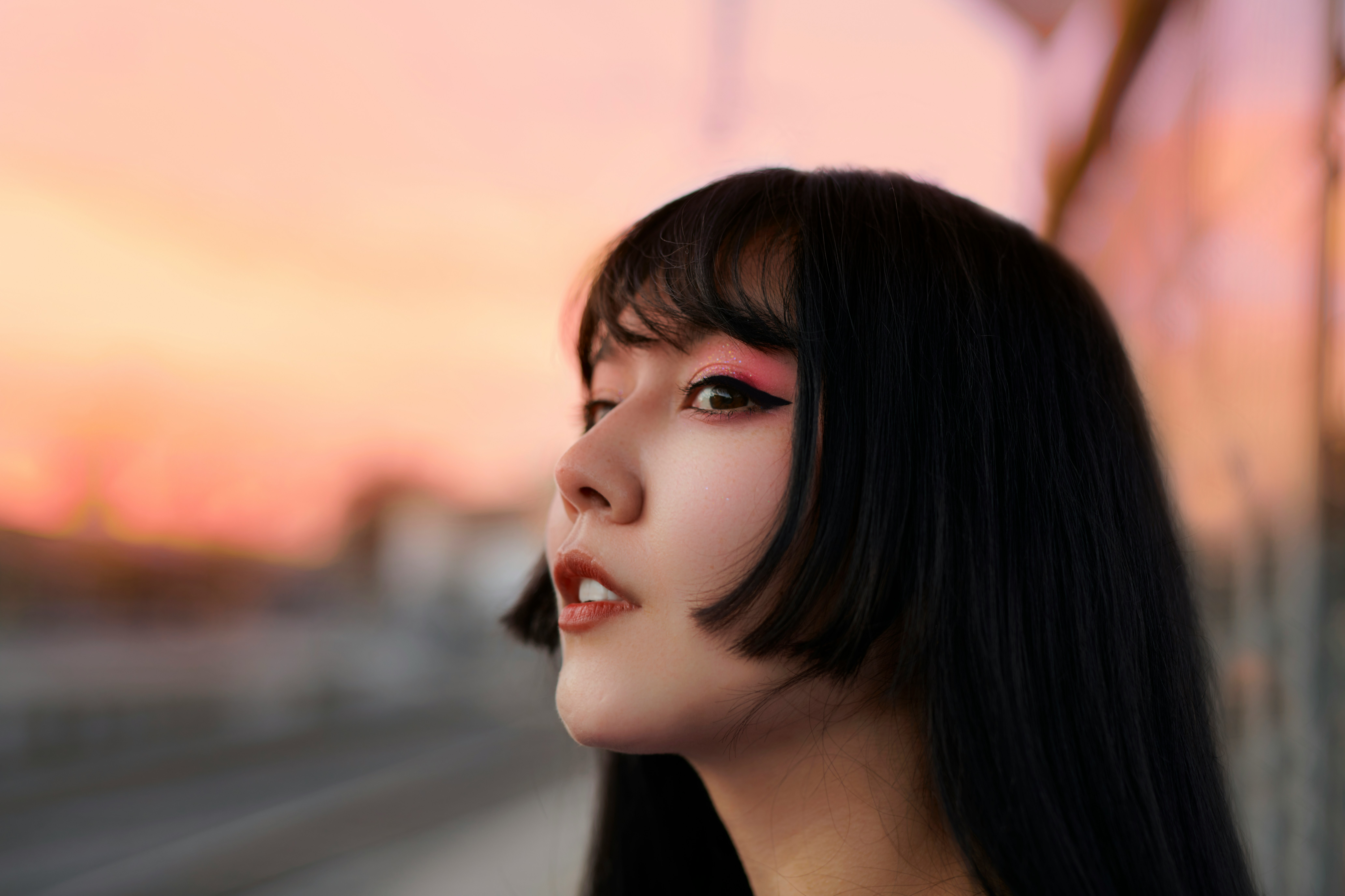 a woman with long black hair and makeup