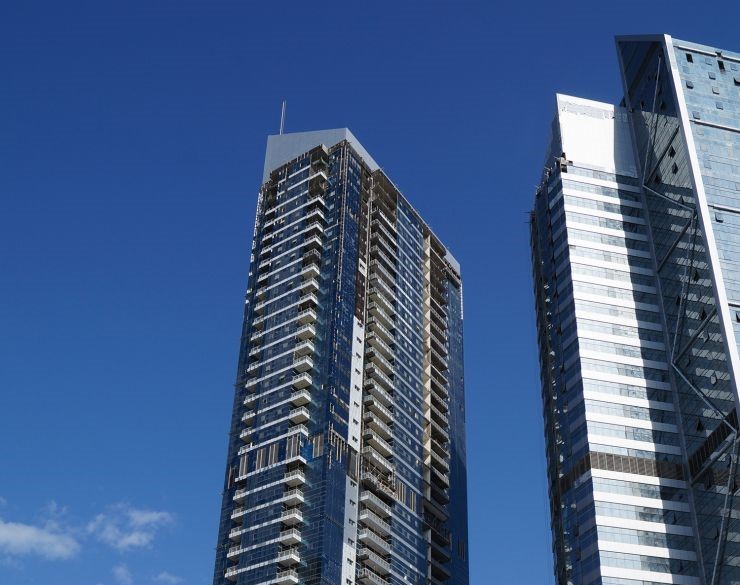 Striking blue glass skyscraper architecture, representing top-tier real estate in Dubai's hub.