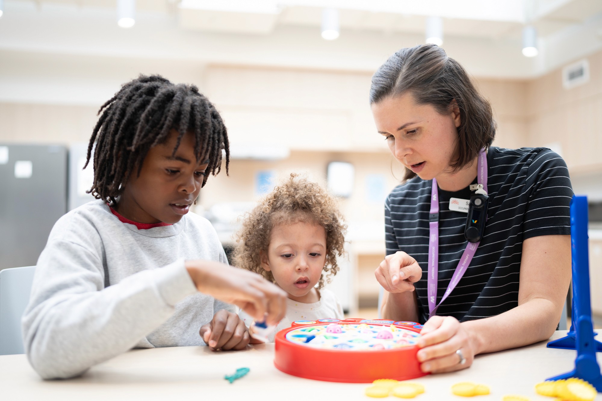 A nurse playing a game with two children