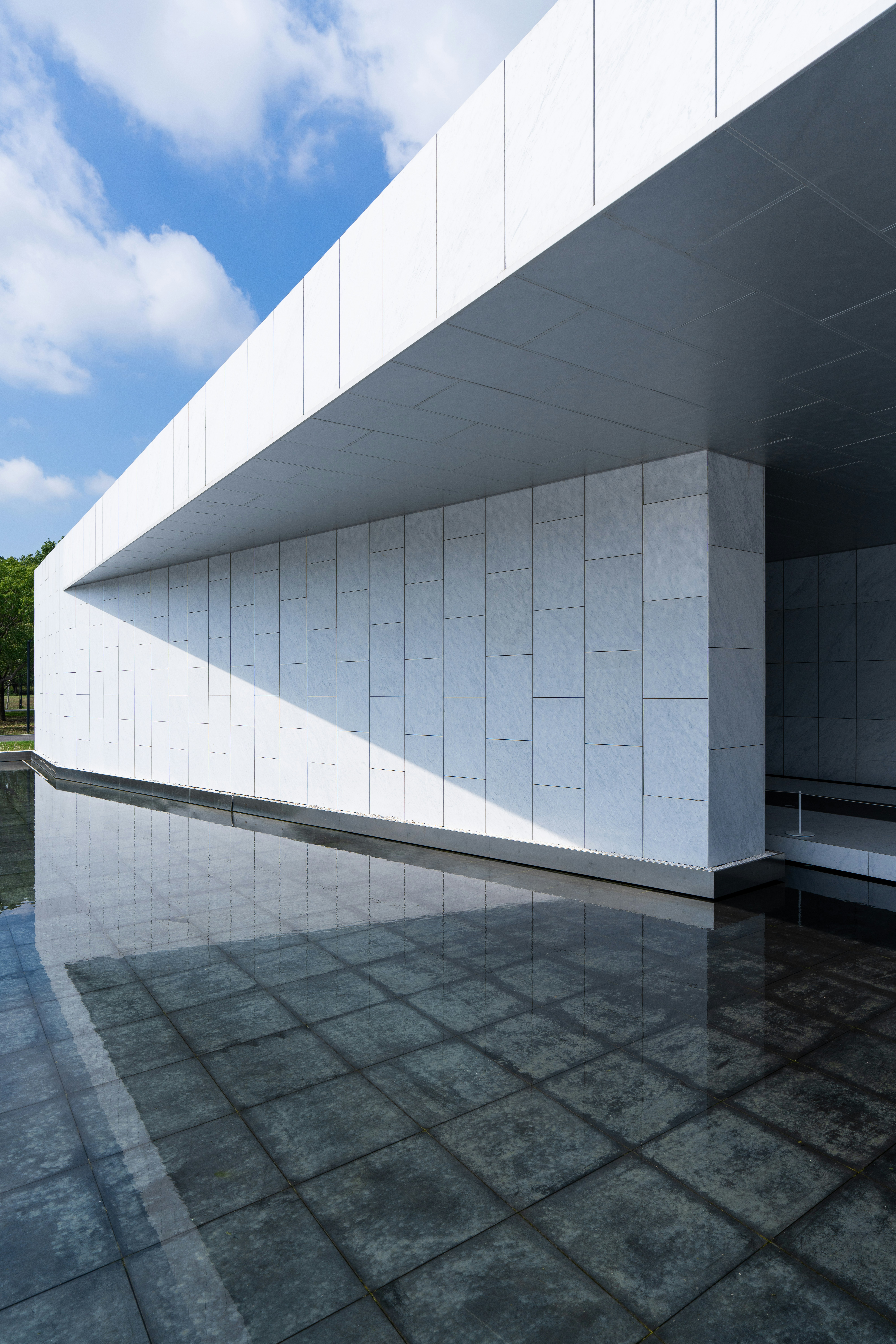 Modern white building with reflection in water