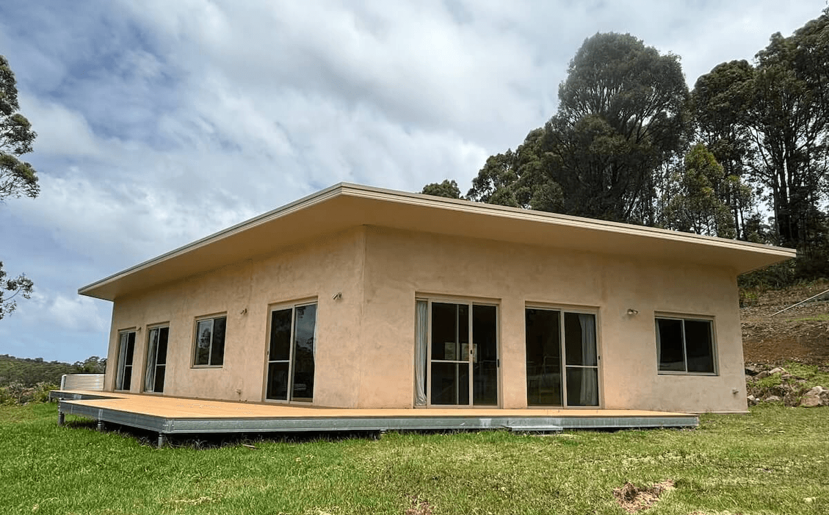 A beautiful exterior view of a house built with hempcrete block walls.