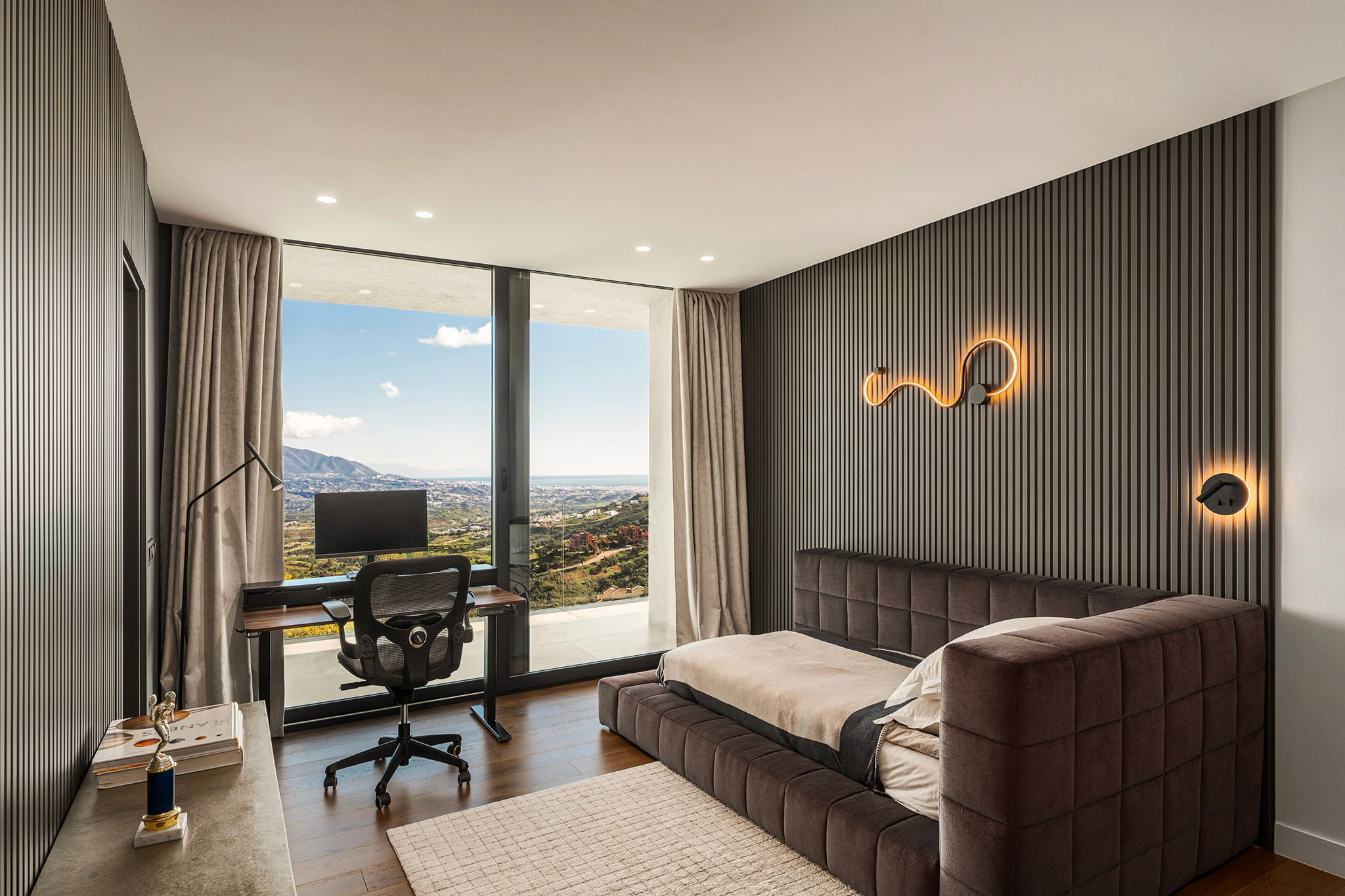 Villa Vista Marbella guest bedroom with fluted feature wall, built-in desk, and panoramic views