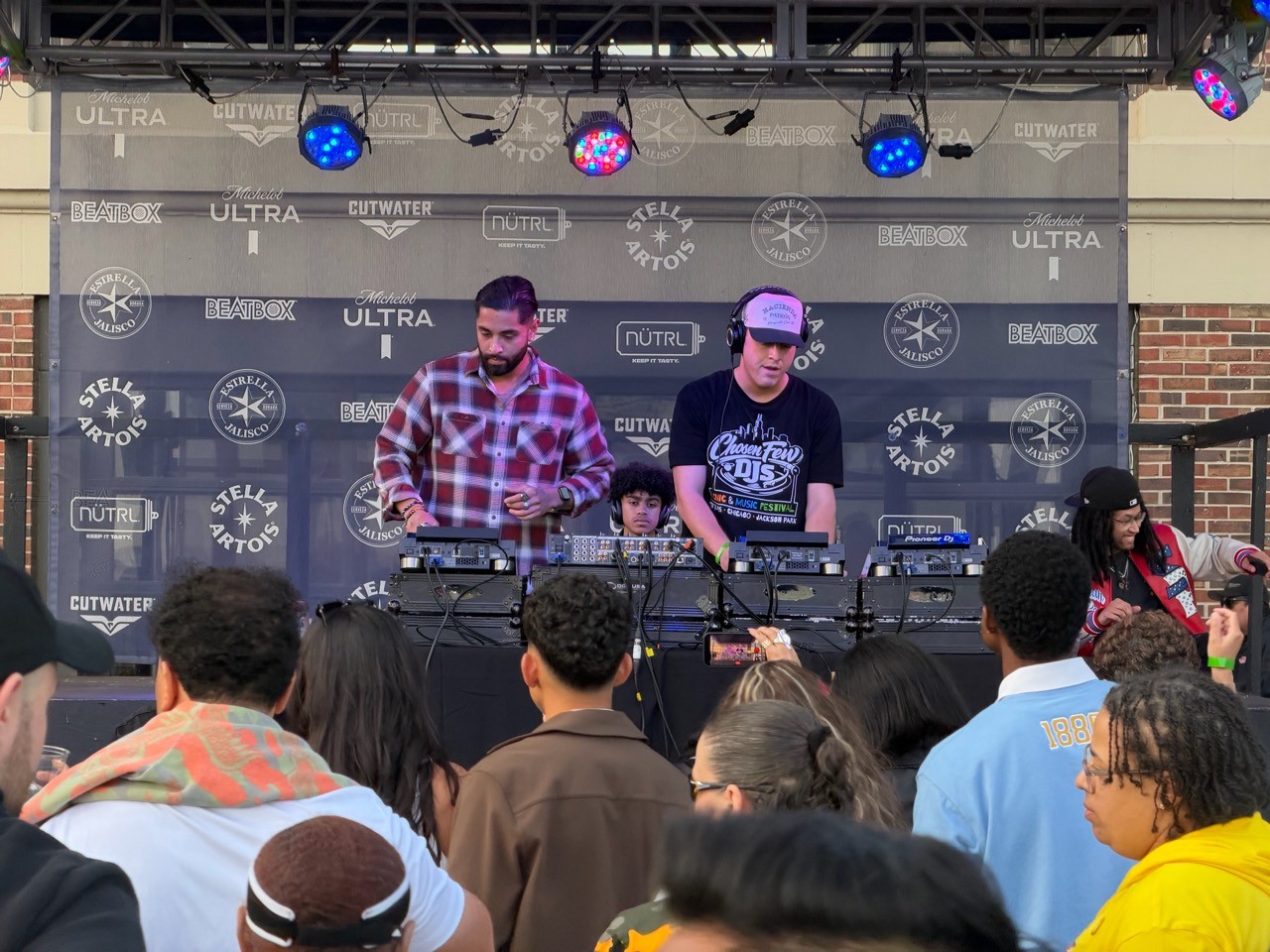 Two DJs perform as the crowd fills in front of the Navy Pier Beer Garden stage.