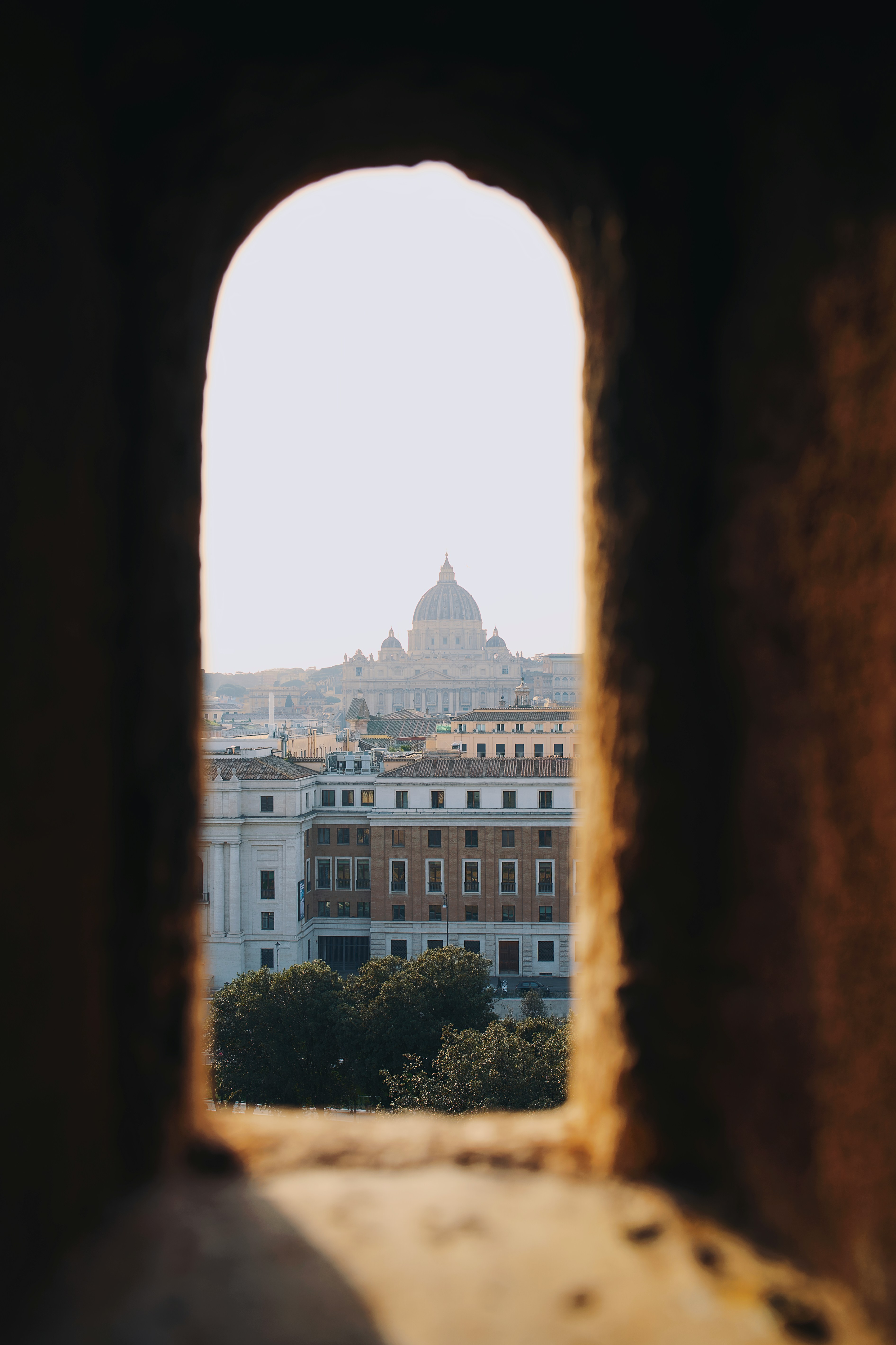 View of st. peter's basilica through an arched window.