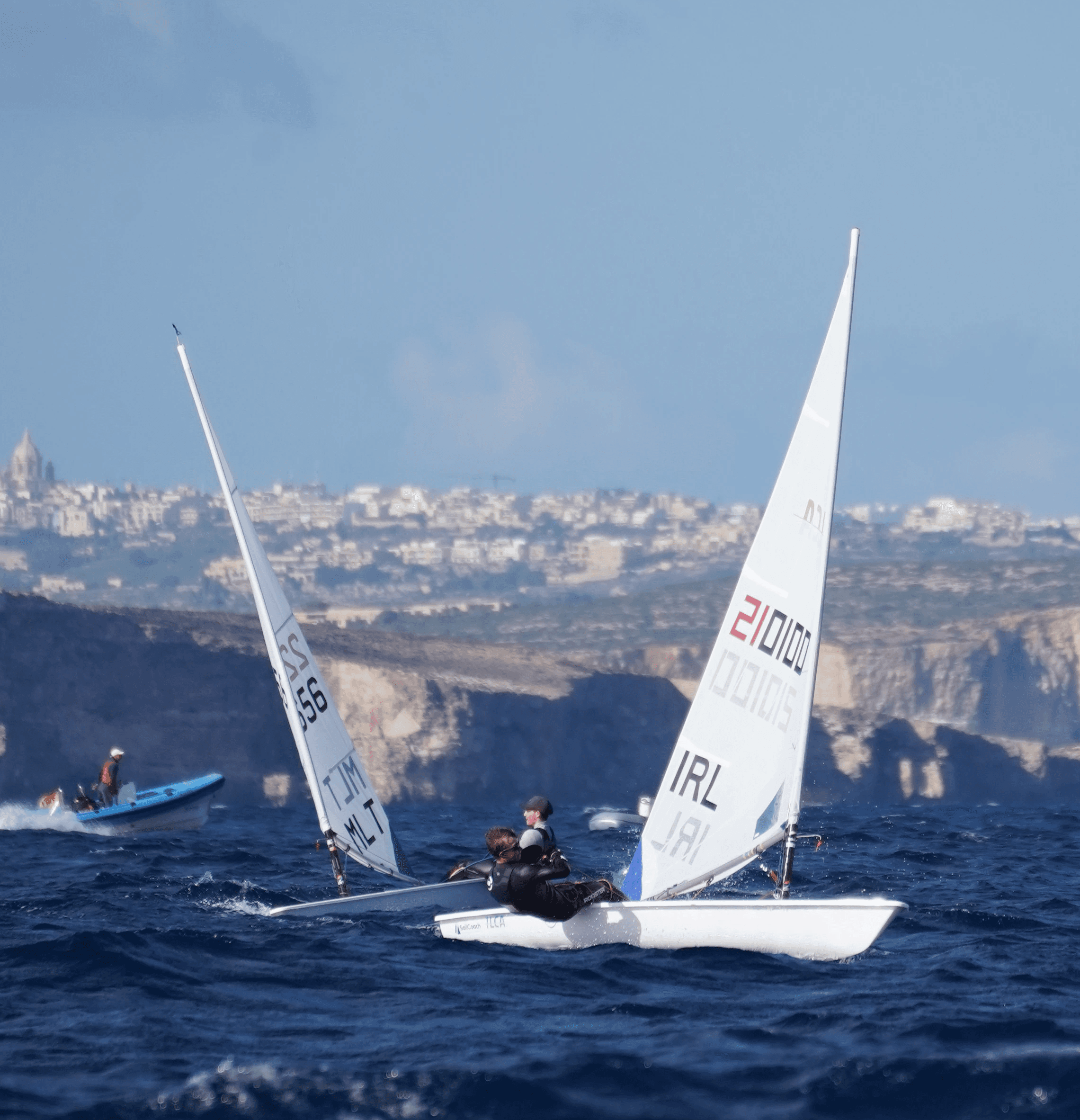 A man stading with Surfboard