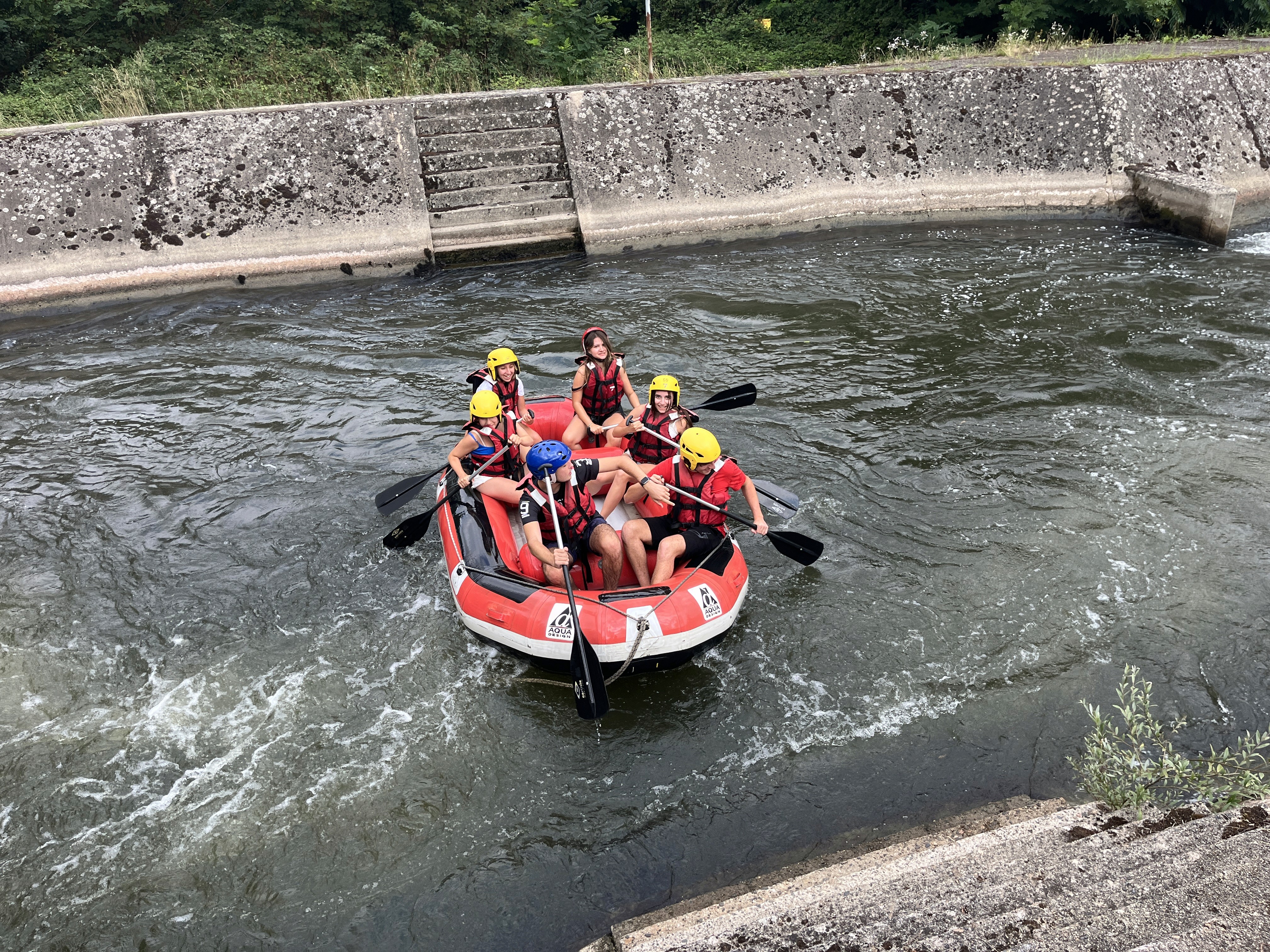 Tall skyscraper dominates a sprawling cityscape at sunset.