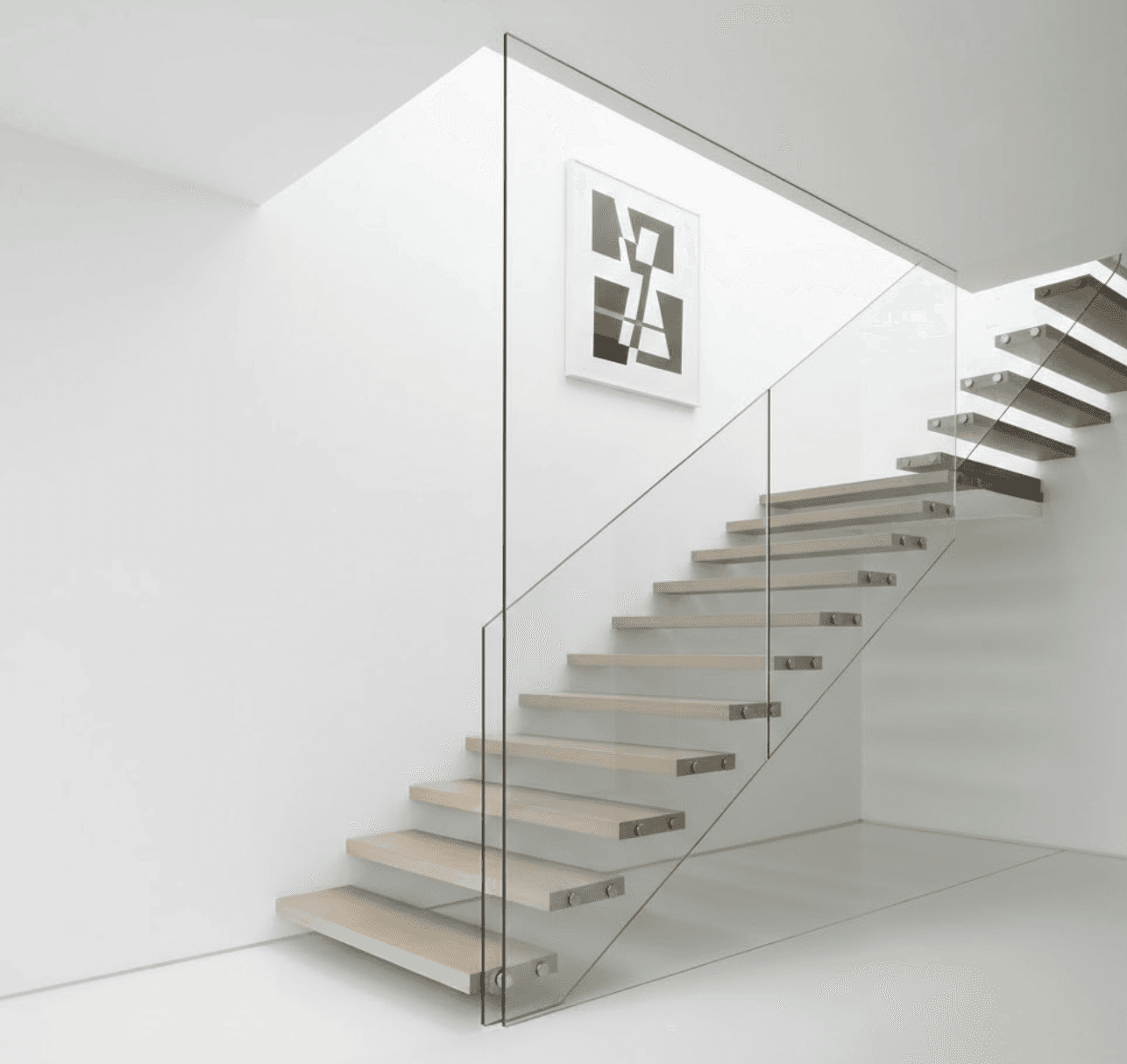 Ultra-minimalist staircase with floating wooden treads and completely frameless glass balustrade. 