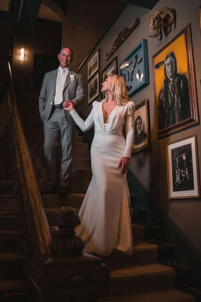 Newlyweds walking down a dark staircase
