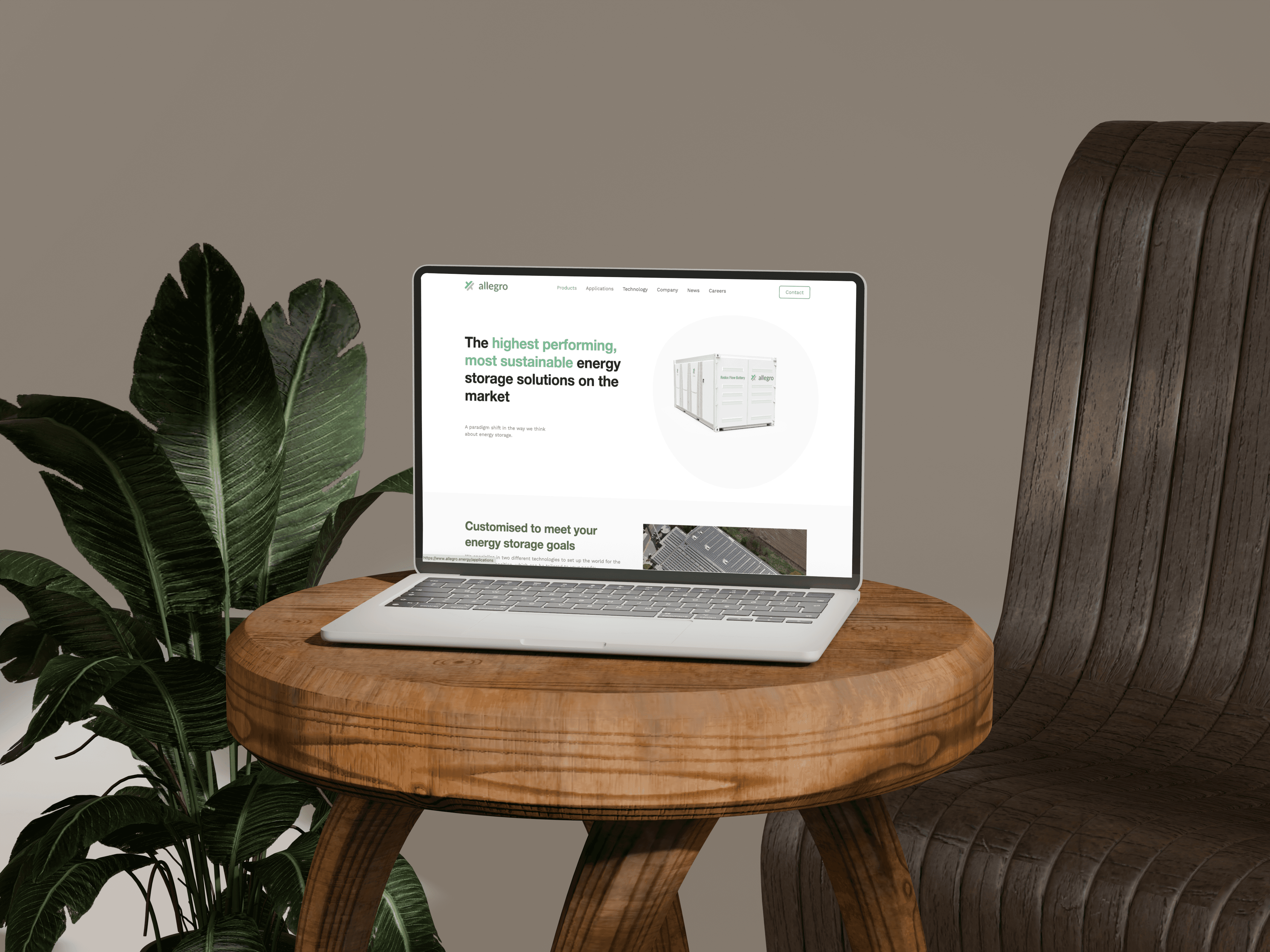 An open laptop sitting on a wooden stool next to a plant
