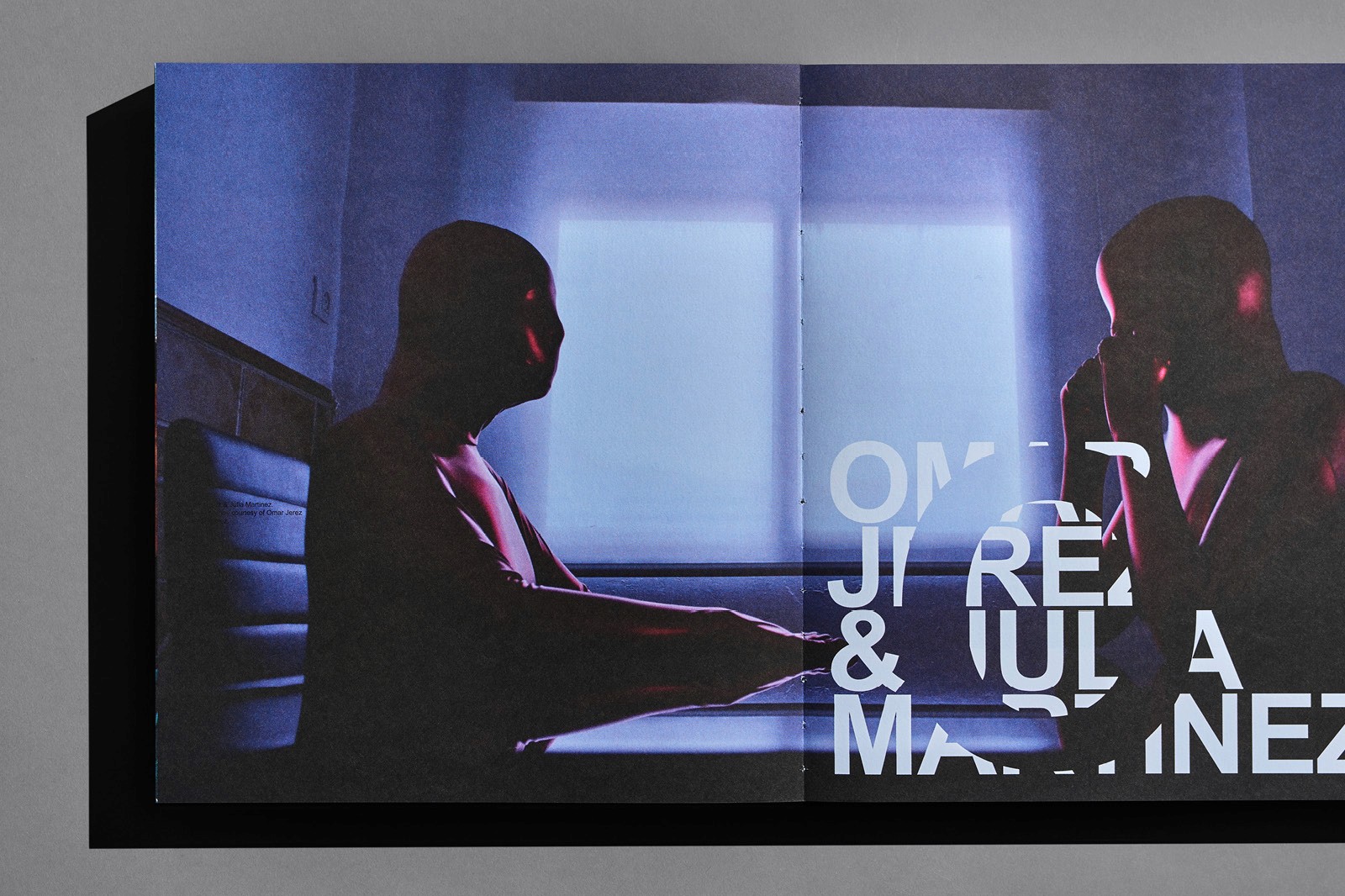 Two silhouetted figures sit across from each other at a table, playing chess in a dimly lit room.