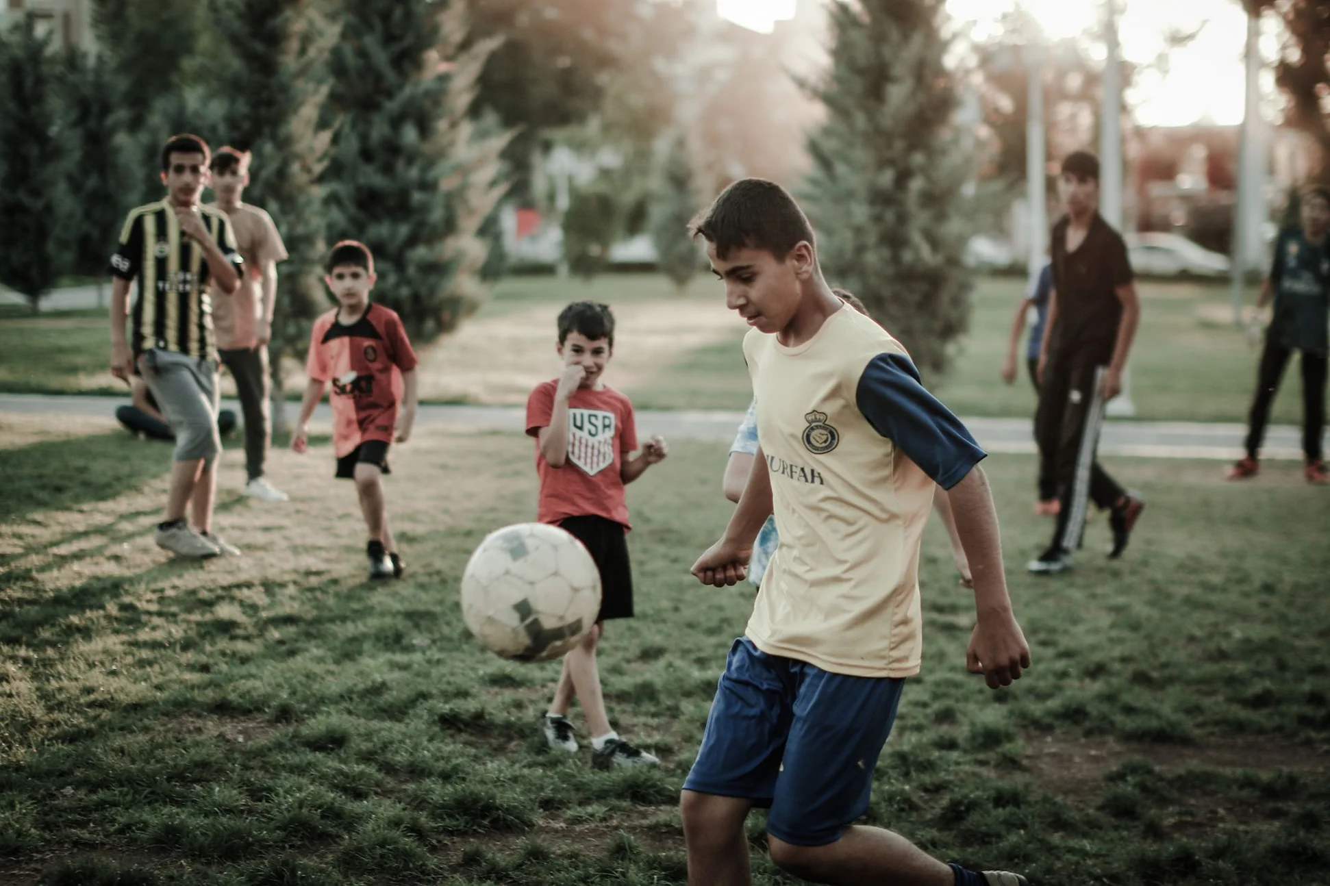 Two players contesting the ball on an artificial-turf field