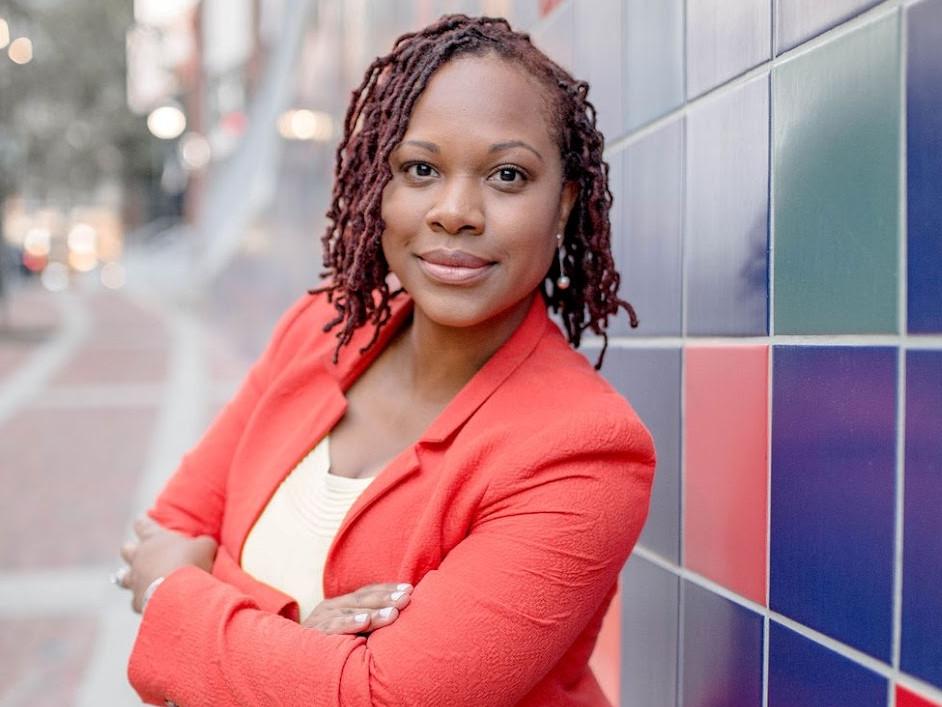 woman in black crew neck t-shirt wearing brown framed eyeglasses standing on rocky shore during