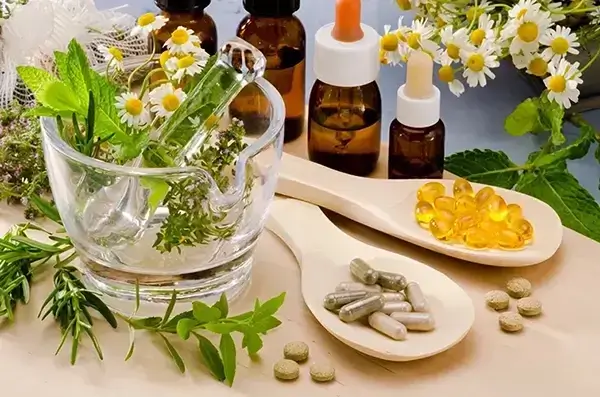 Herbal remedies with mortar and pestle, essential oil bottles, and natural supplements.