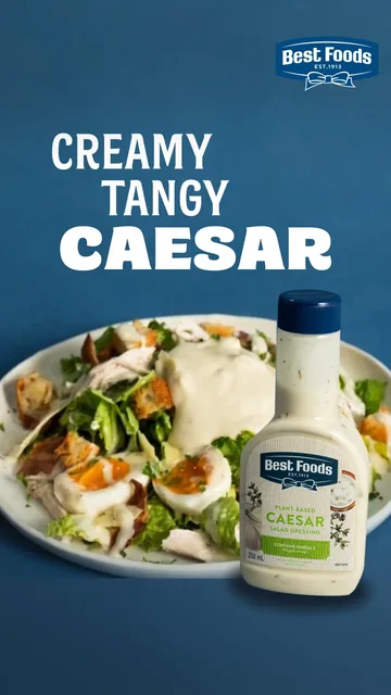 A Caesar salad beside a bottle of Best Foods Caesar dressing