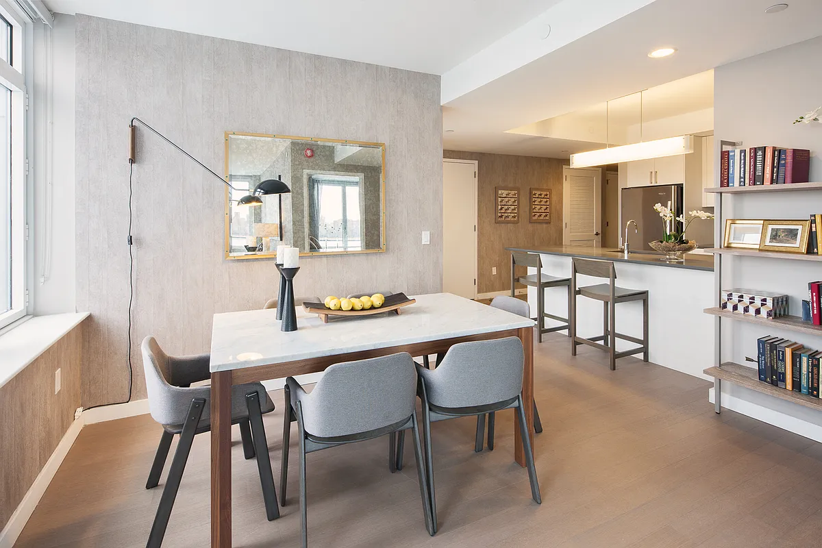 A stylish condo kitchen and dining space, showcasing modern design elements and a bright, open layout.