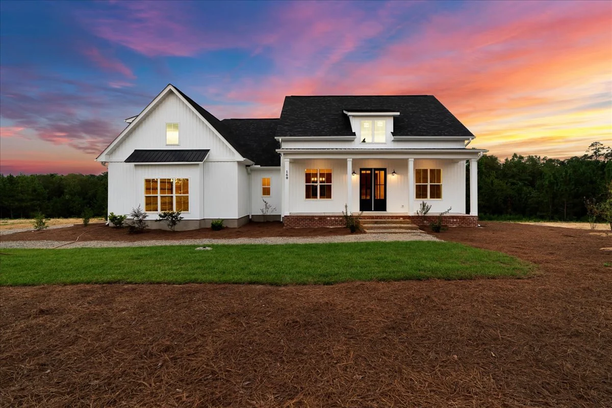 Custom farmhouse at dusk built by TL Hardin Group