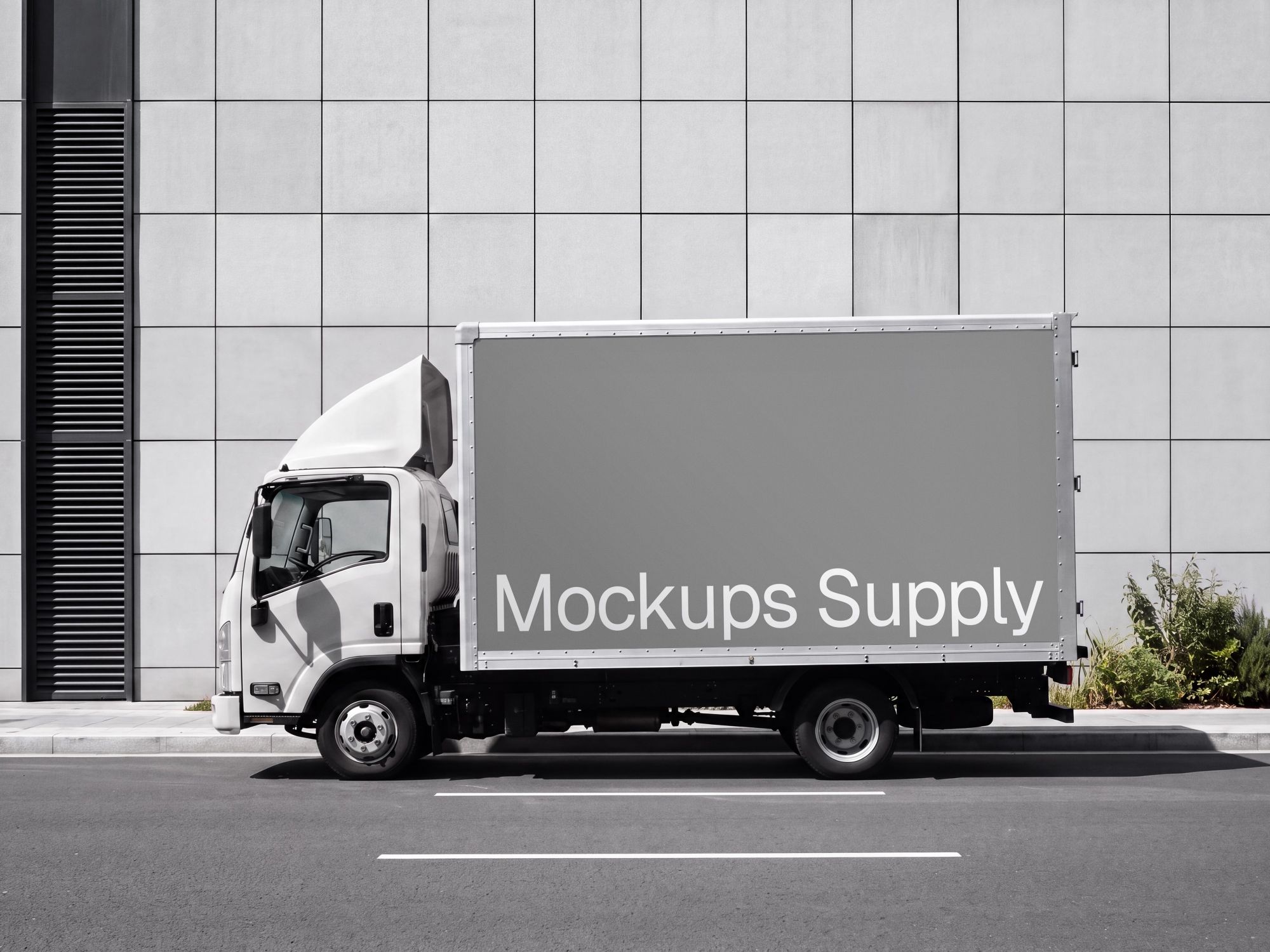 Commercial truck mockup by office building shown from the side with a large cargo panel and modern facade