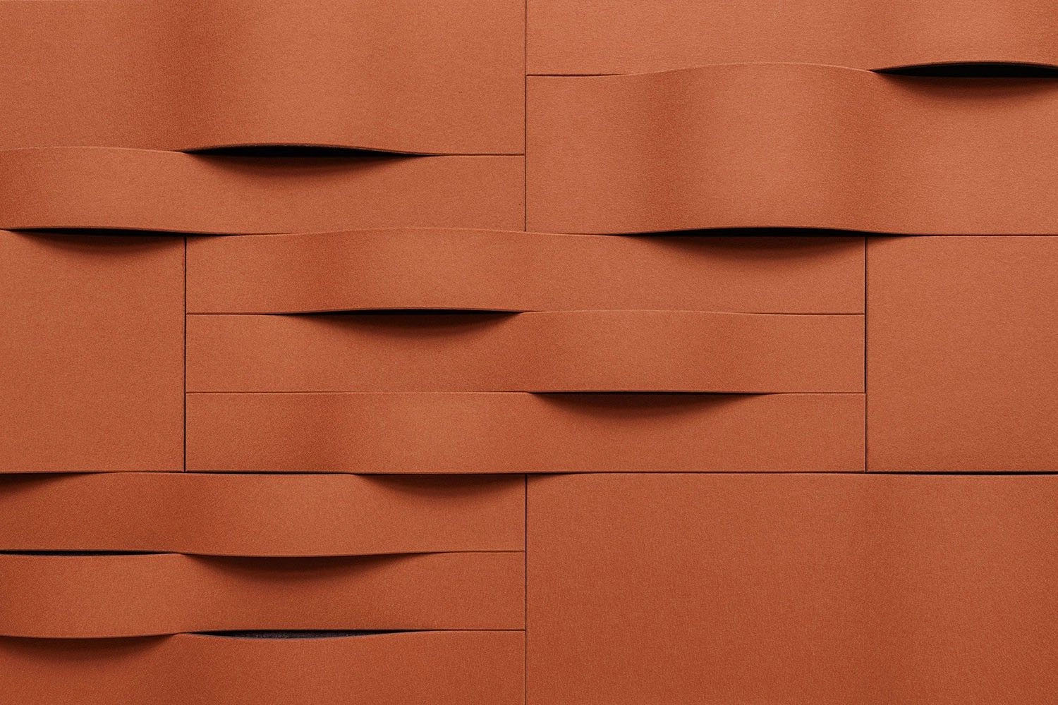 Woven terracotta wall tiles with curved interlacing strips