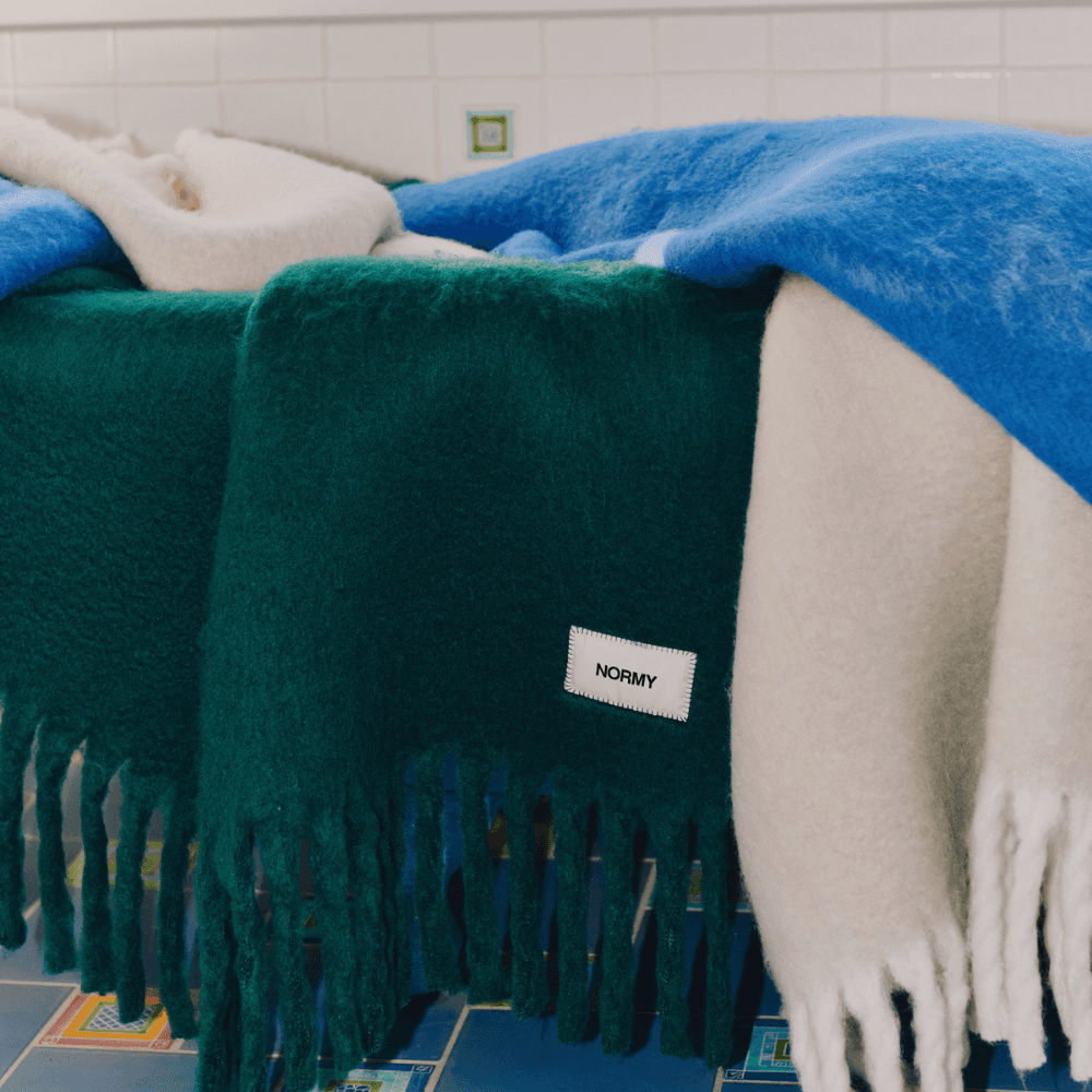 Close up of mohair blankets draped over bathtub