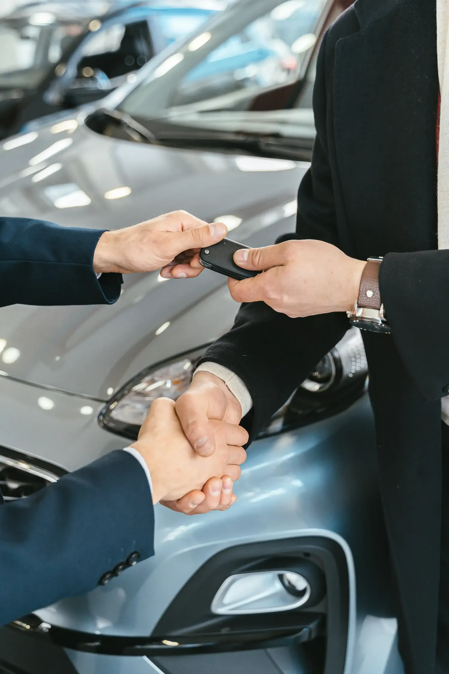 Handing over car keys and shaking hands