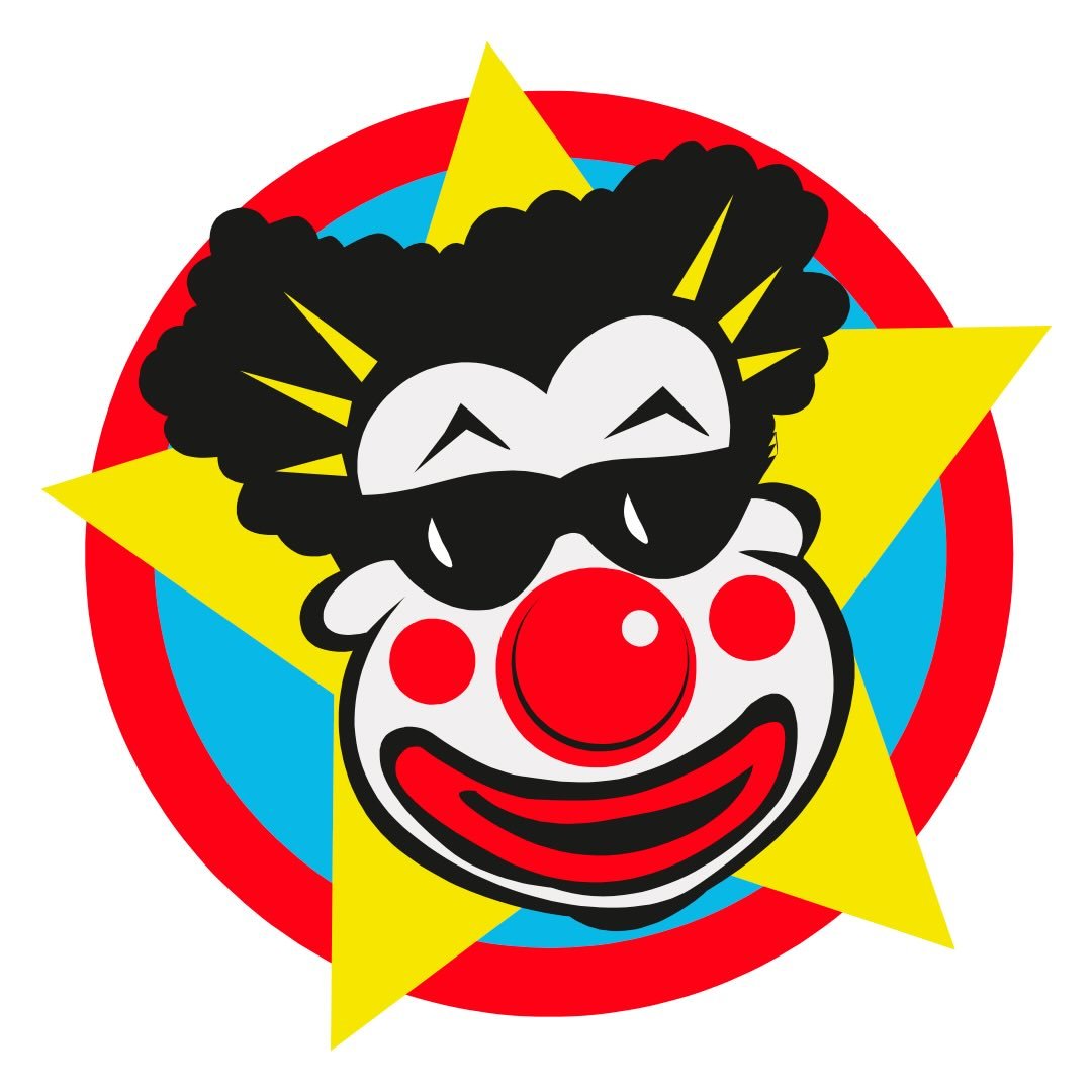 A woman with blonde bob hair in a grey coat and beige turtleneck stands against a neutral backdrop. She has a serious expression, conveying elegance.