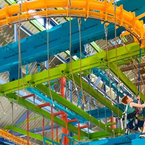 High ropes course with obstacles and curved rails.