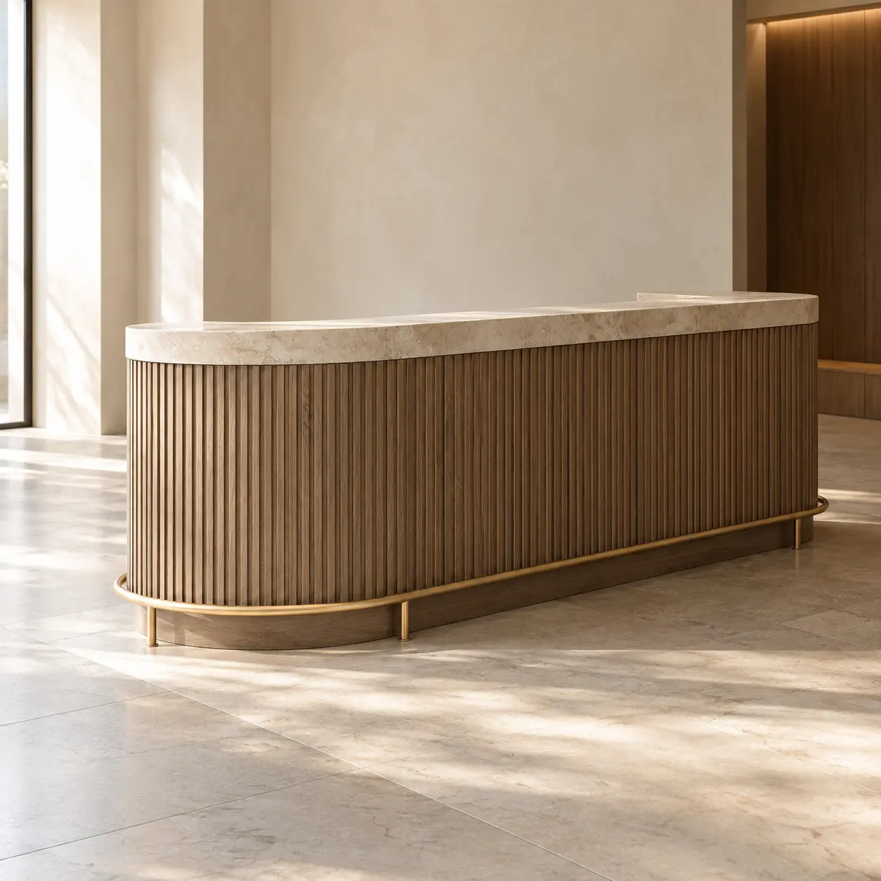 Curved reception desk in fluted oak with a stone top and a brass foot rail