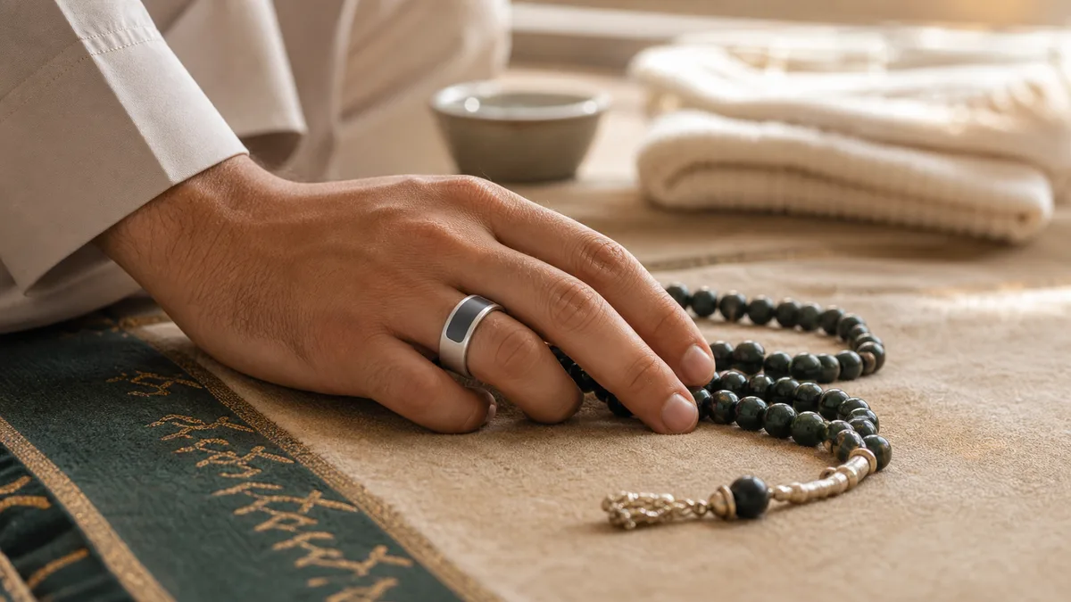 Hand wearing a smart tasbih ring beside traditional misbaha beads on a prayer mat
