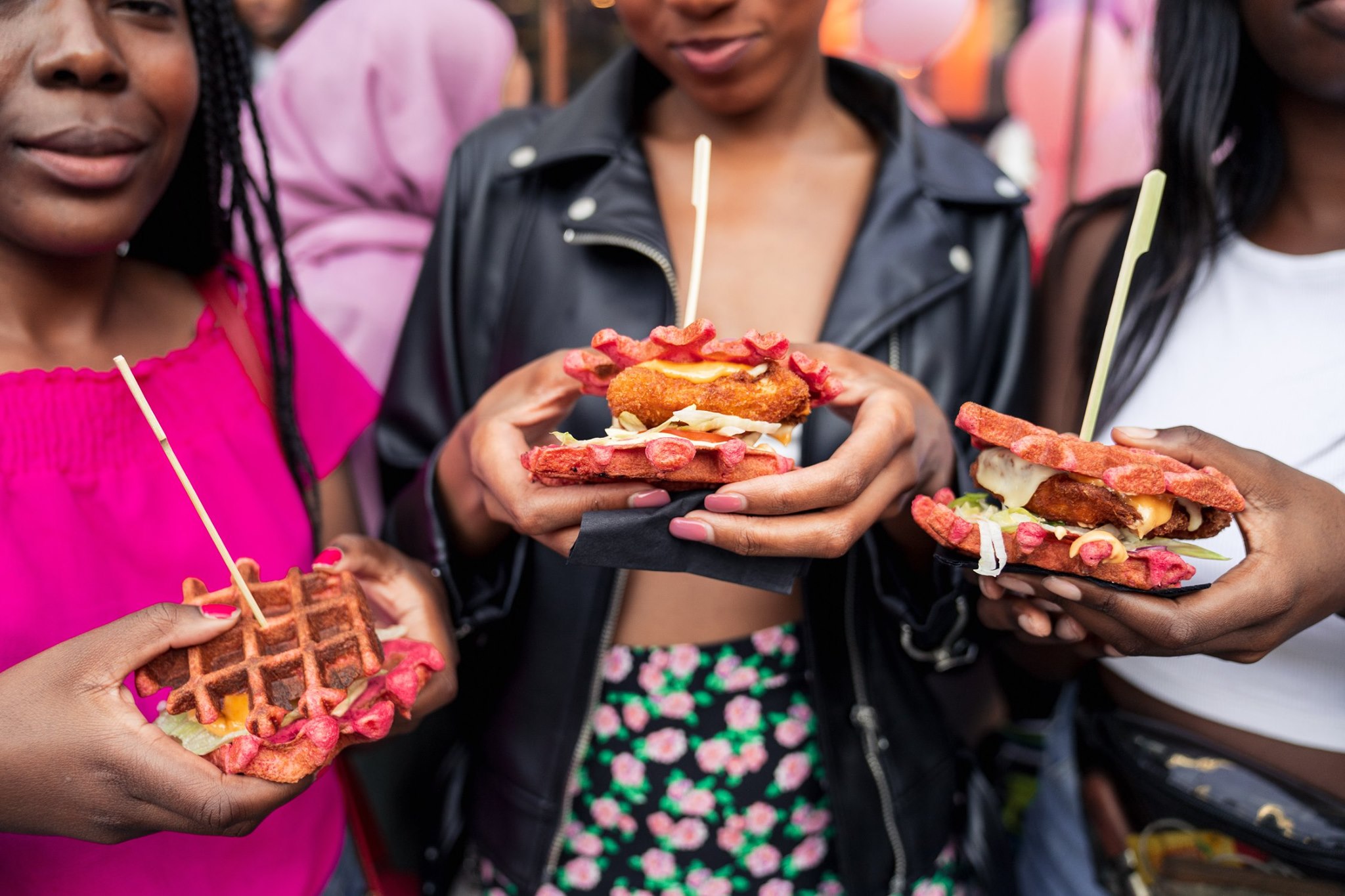 Modern home office setup with a monitor, ergonomic chair, keyboard, and indoor plants near a window with blinds.