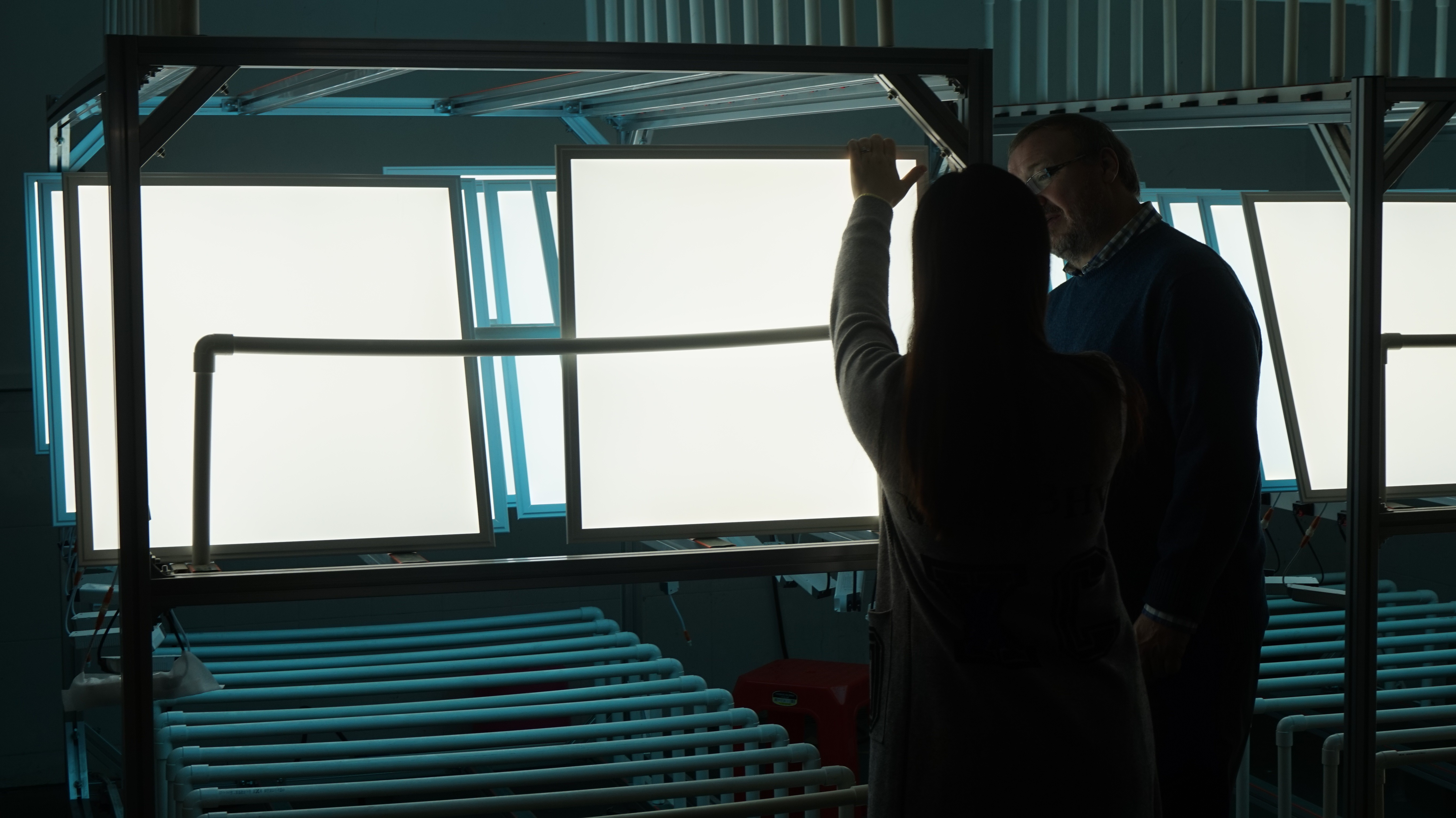 John Eastwood inspects LED pannels in a factory in China