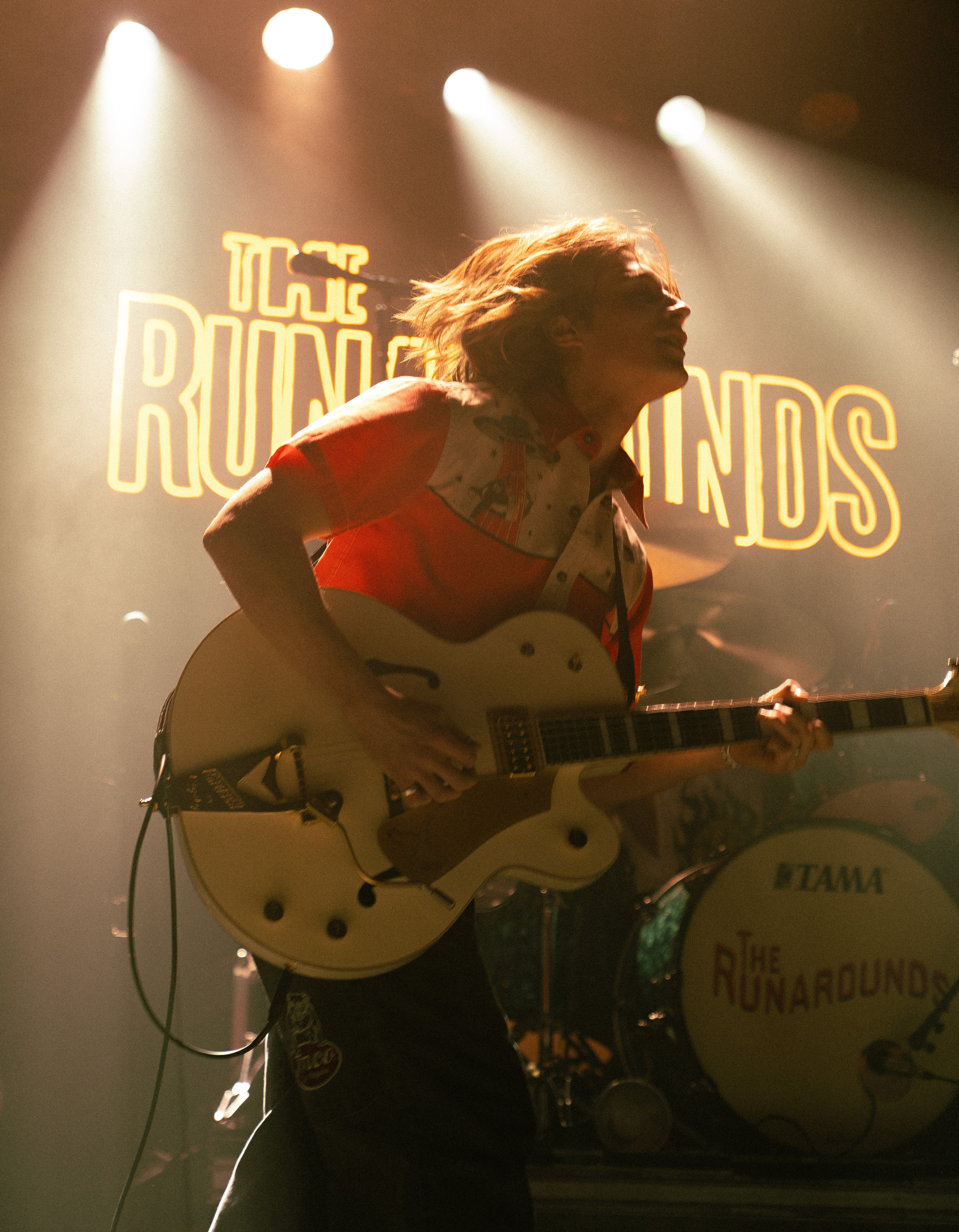 A girl holding a vintage-style camera while smoking a cigarette.