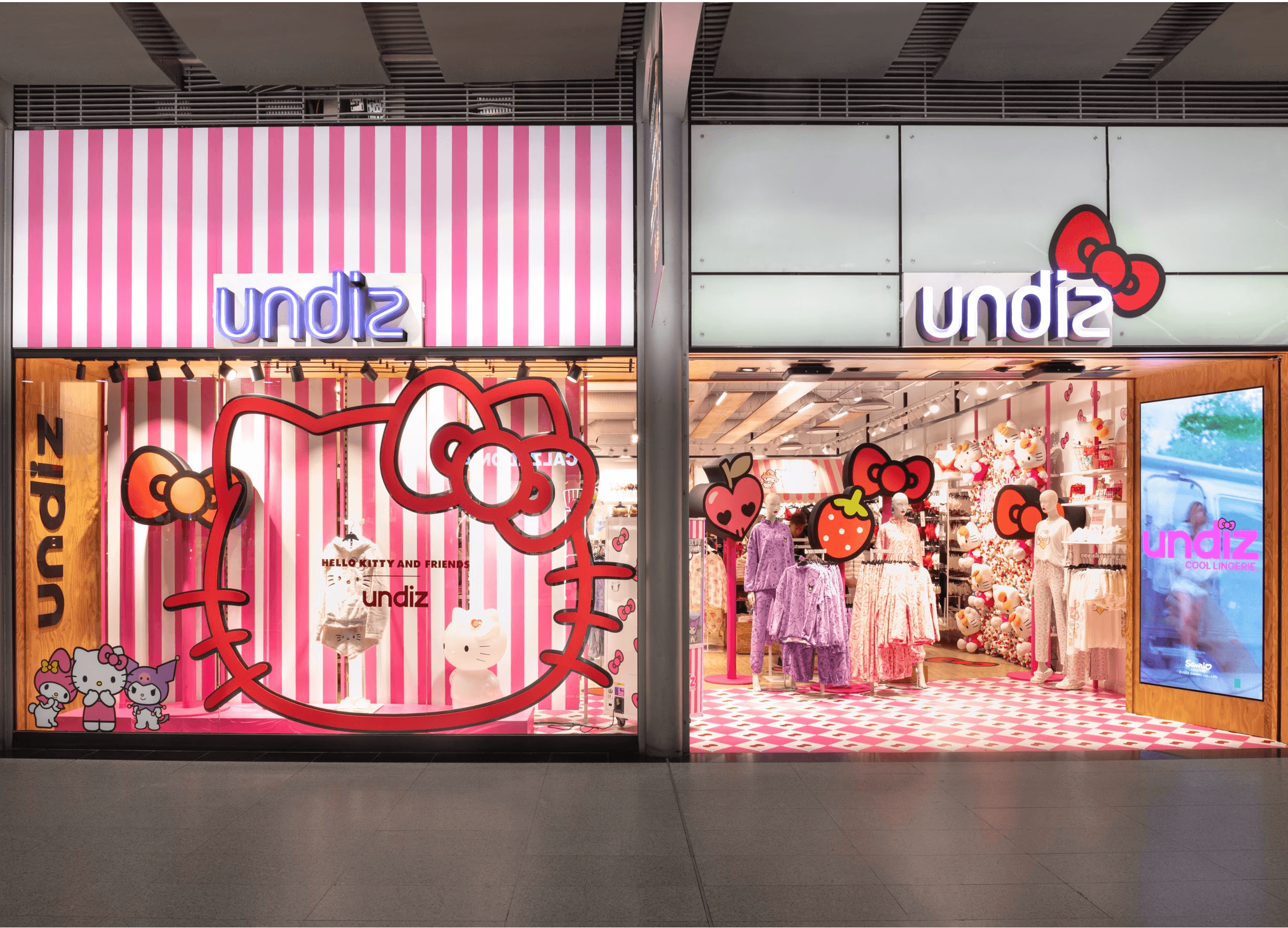 Devanture Undiz décorée pour la collection Hello Kitty, avec rayures roses, nœuds rouges et peluches en vitrine.