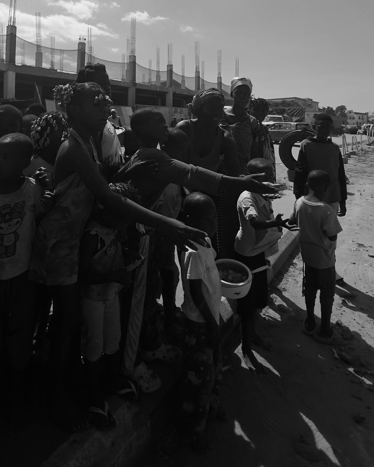 a group of children sitting on steps in front of a building