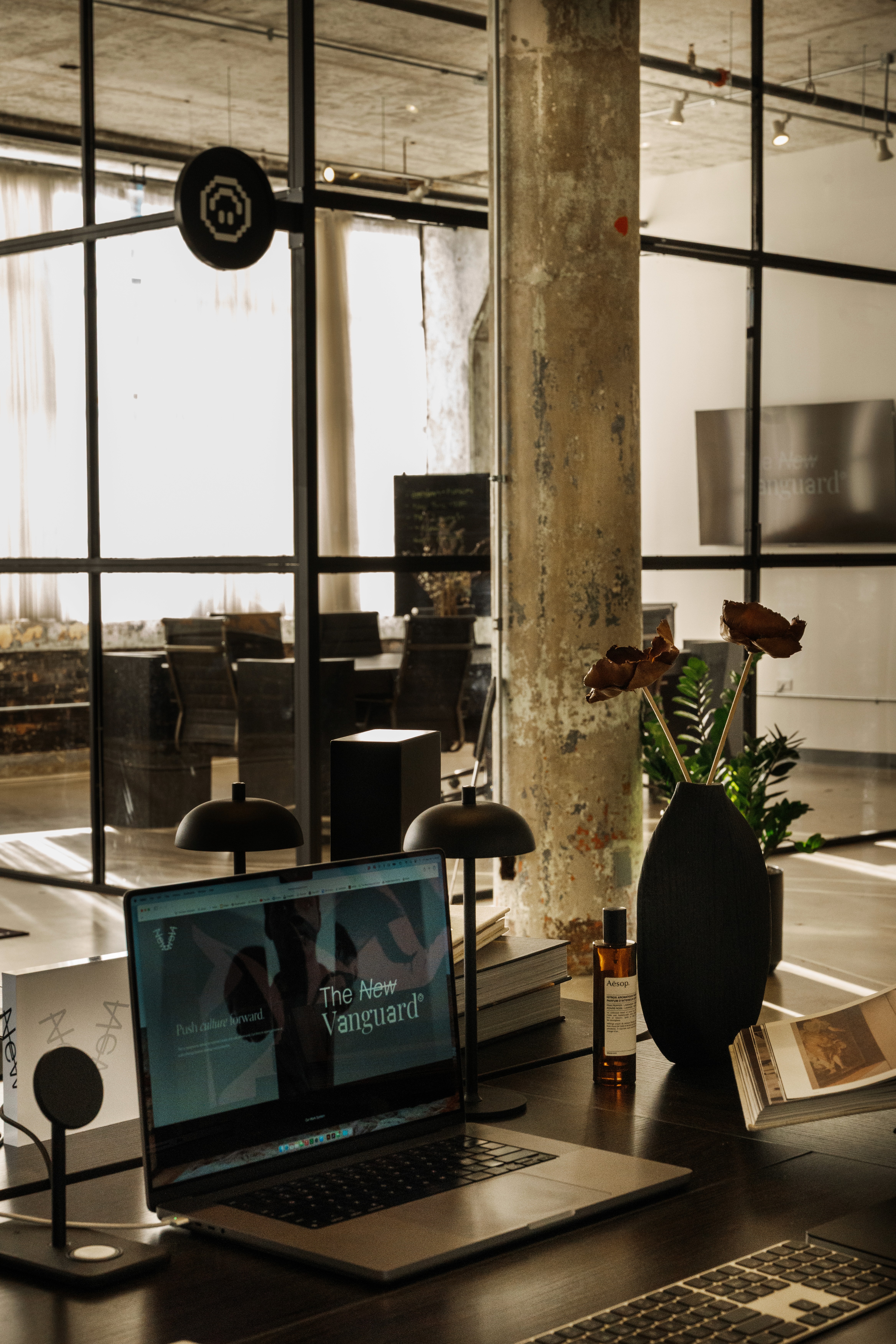 Laptop on table with studio office in the background
