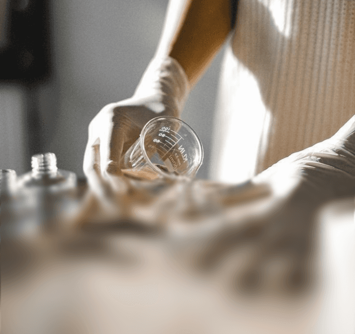 Close-up of hands working with equipment, representing the challenges and realities of building and managing your own manufacturing operations.