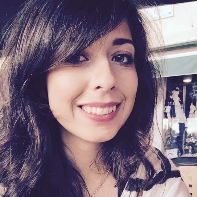 man smiling while sitting on floor during daytime