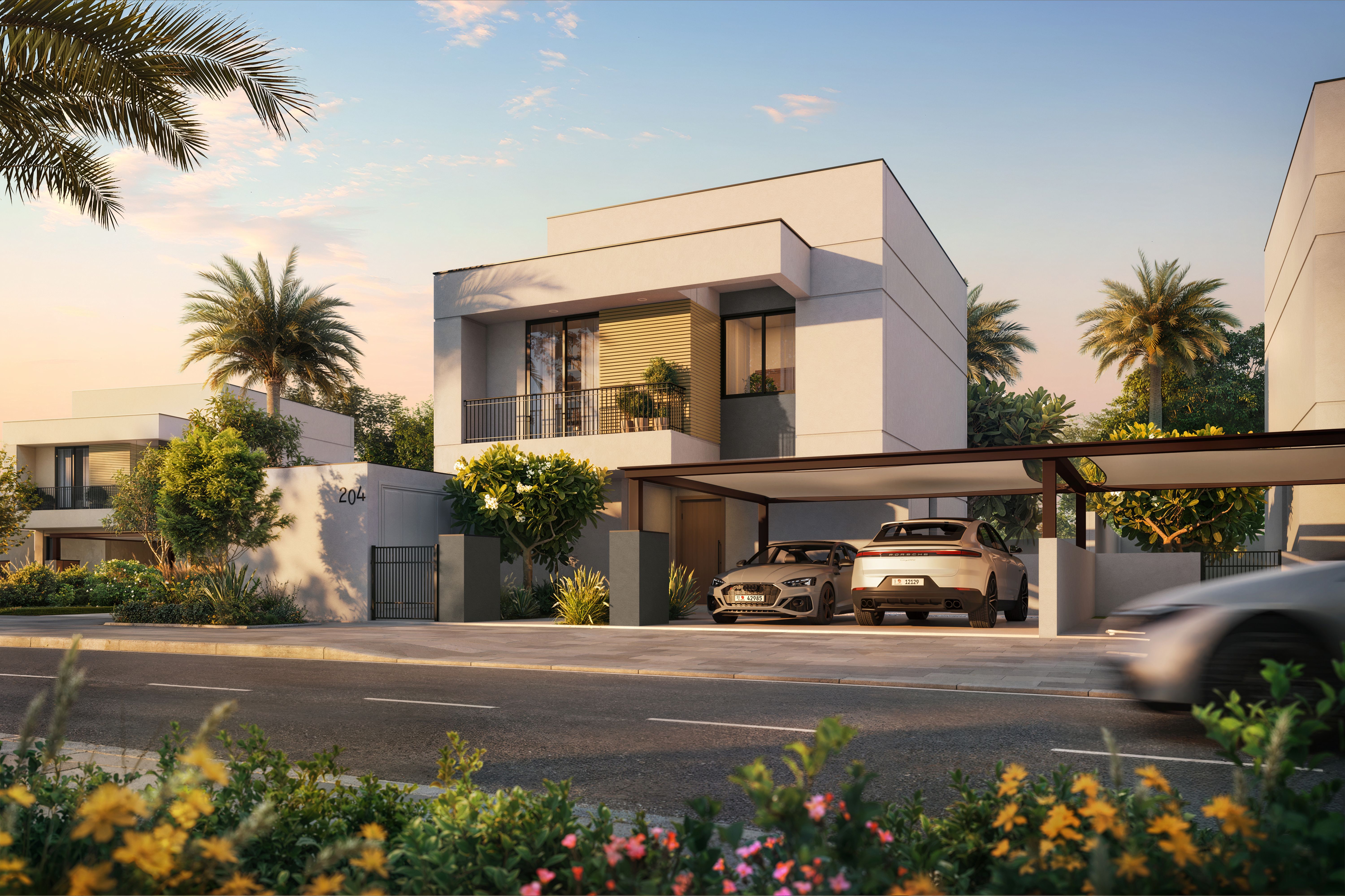 A modern villa with a sleek glass facade overlooks an infinity pool at sunset. Palm trees line the edge, with a distant city skyline aglow.