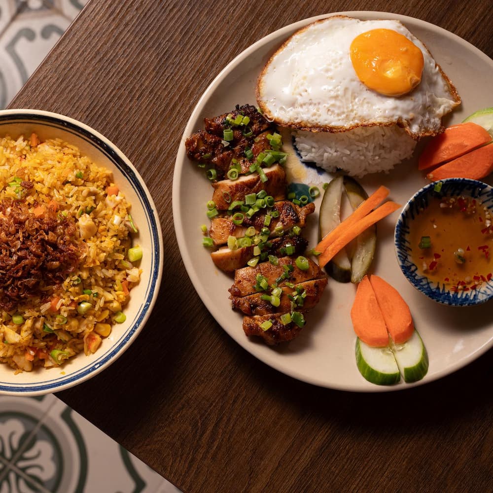 Saigon-style steamed broken rice with chicken and a sunny-side-up egg, served for brunch in Downtown Dubai at Social Distrikt.